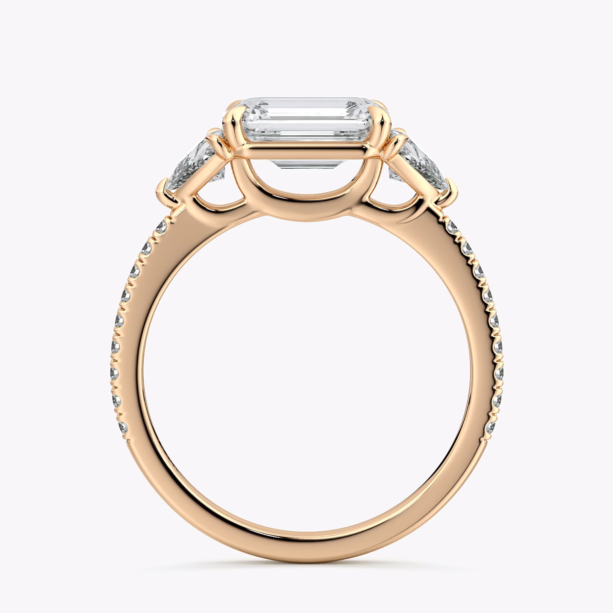 The Three Stone | Emerald | 14k | Rose Gold | bandAccent: Pavé | diamondOrientation: horizontal | sideStoneCarat: 0.25ct | sideStoneShape: Trillion | caratWeight: other