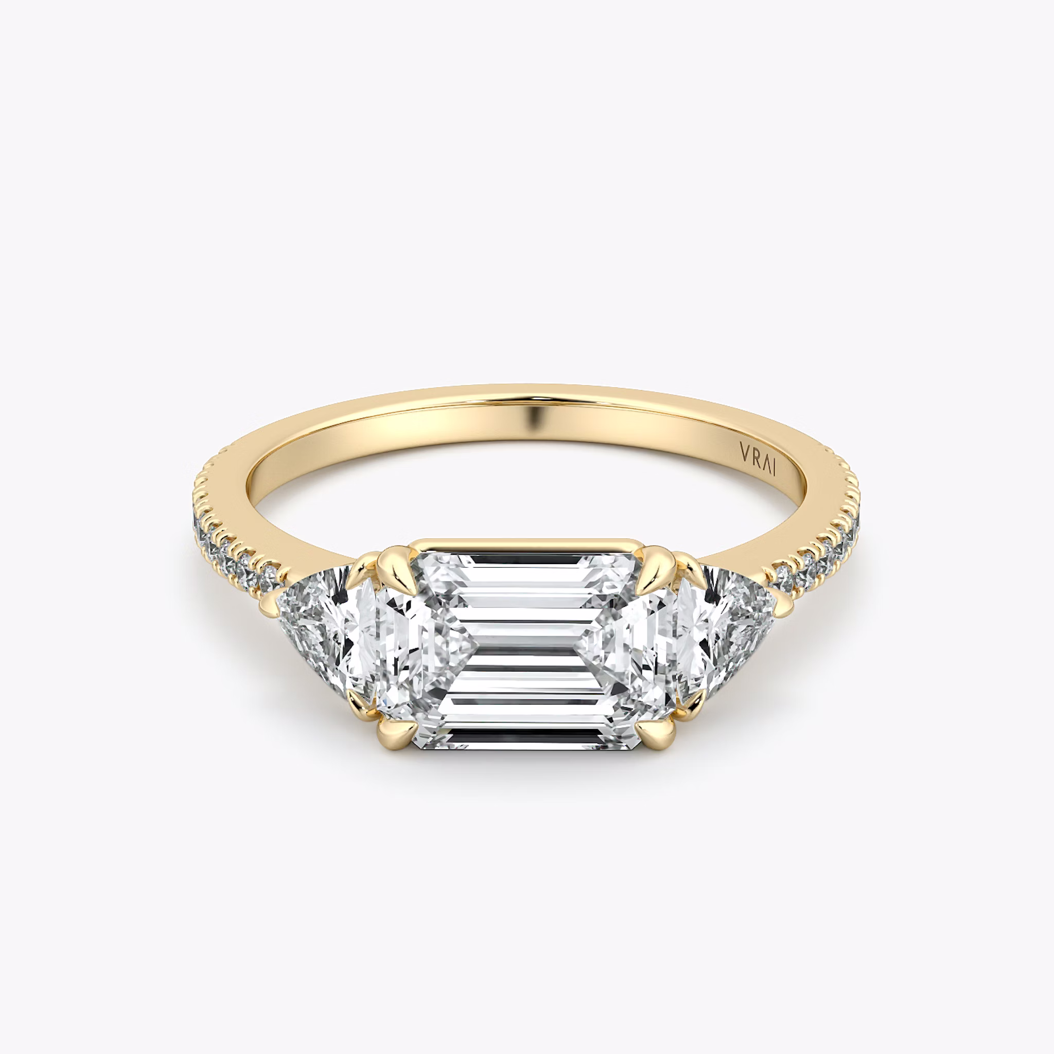The Three Stone | Emerald | 18k | Yellow Gold | bandAccent: Pavé | diamondOrientation: horizontal | sideStoneCarat: 0.25ct | sideStoneShape: Trillion | caratWeight: other