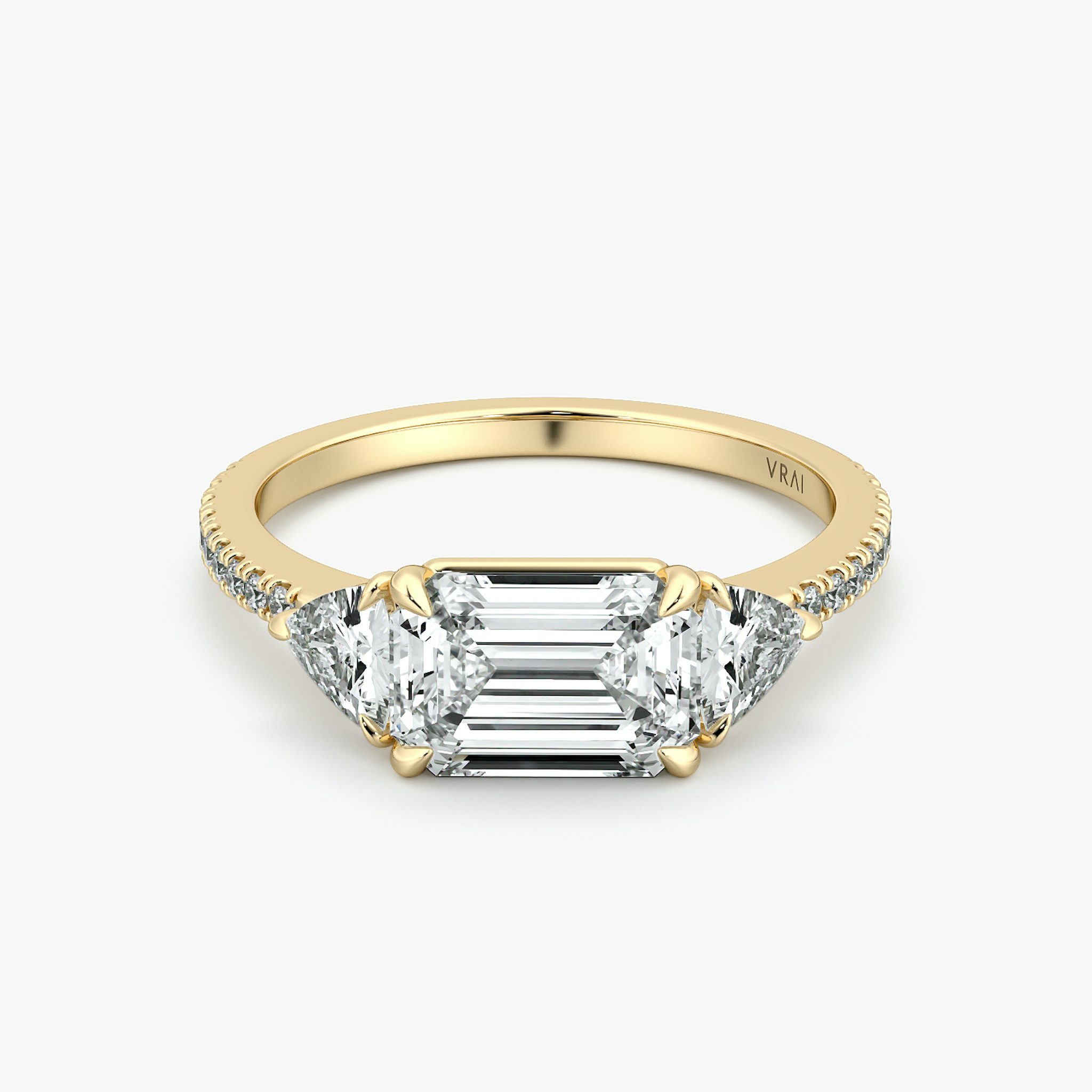 The Three Stone | Emerald | 18k | Yellow Gold | bandAccent: Pavé | diamondOrientation: horizontal | sideStoneCarat: 0.25ct | sideStoneShape: Trillion | caratWeight: other