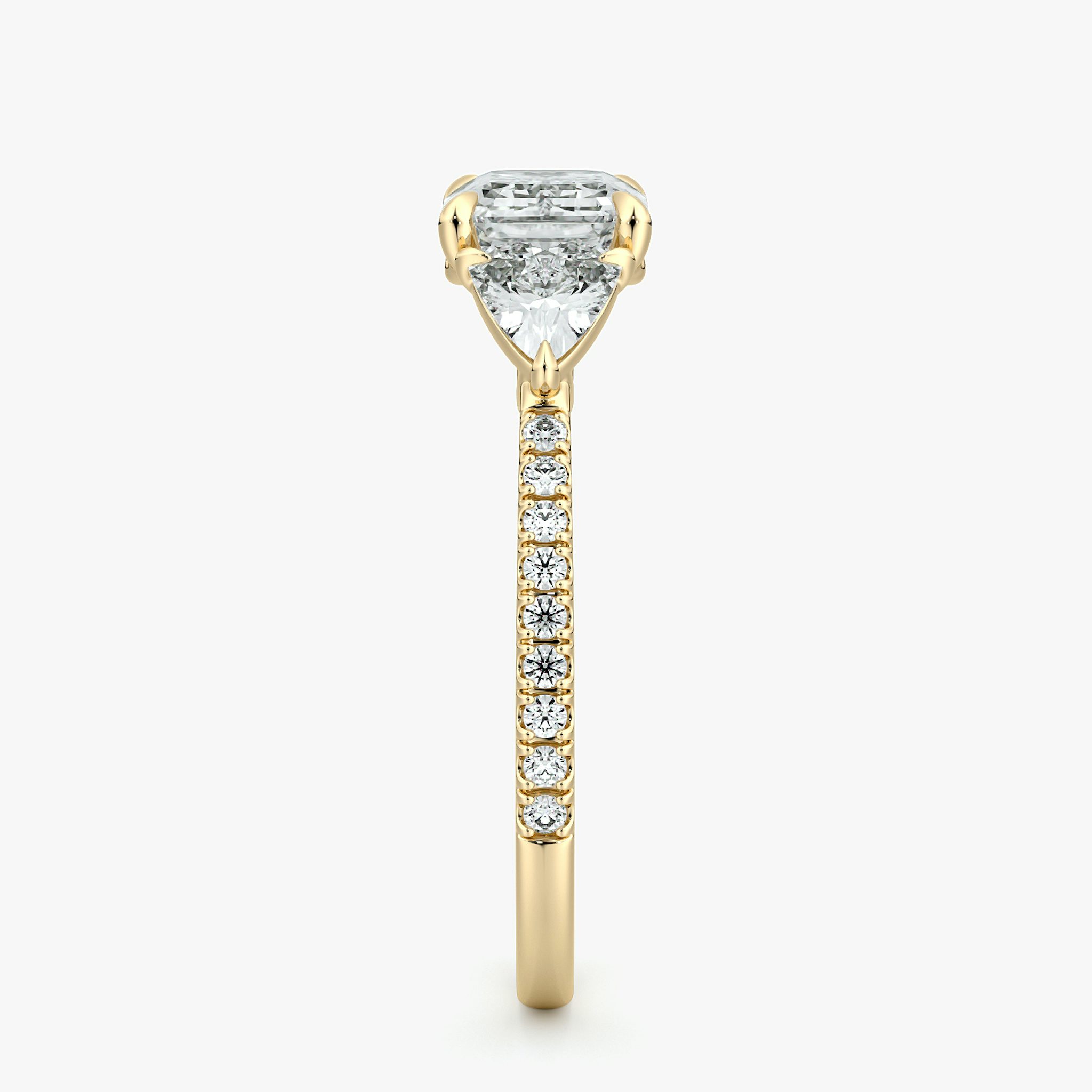 The Three Stone | Emerald | 18k | Yellow Gold | bandAccent: Pavé | diamondOrientation: horizontal | sideStoneCarat: 0.25ct | sideStoneShape: Trillion | caratWeight: other
