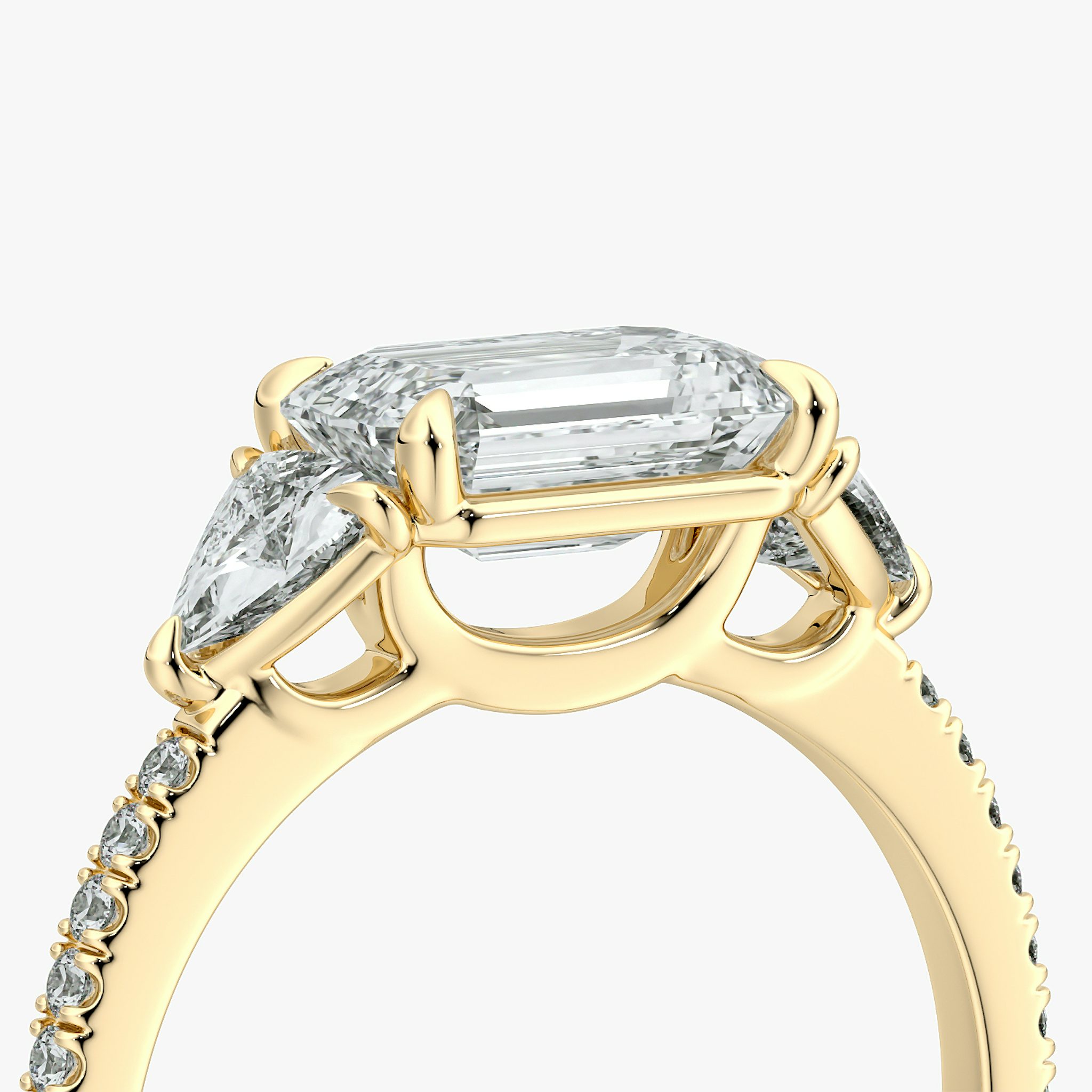 The Three Stone | Emerald | 18k | Yellow Gold | bandAccent: Pavé | diamondOrientation: horizontal | sideStoneCarat: 0.25ct | sideStoneShape: Trillion | caratWeight: other