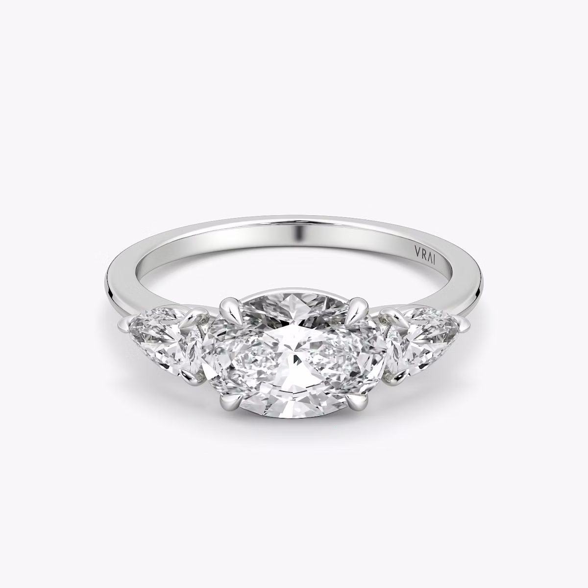 The Three Stone | Oval | Platinum | bandAccent: Plain | diamondOrientation: horizontal | sideStoneCarat: 0.25ct | sideStoneShape: Pear | caratWeight: other