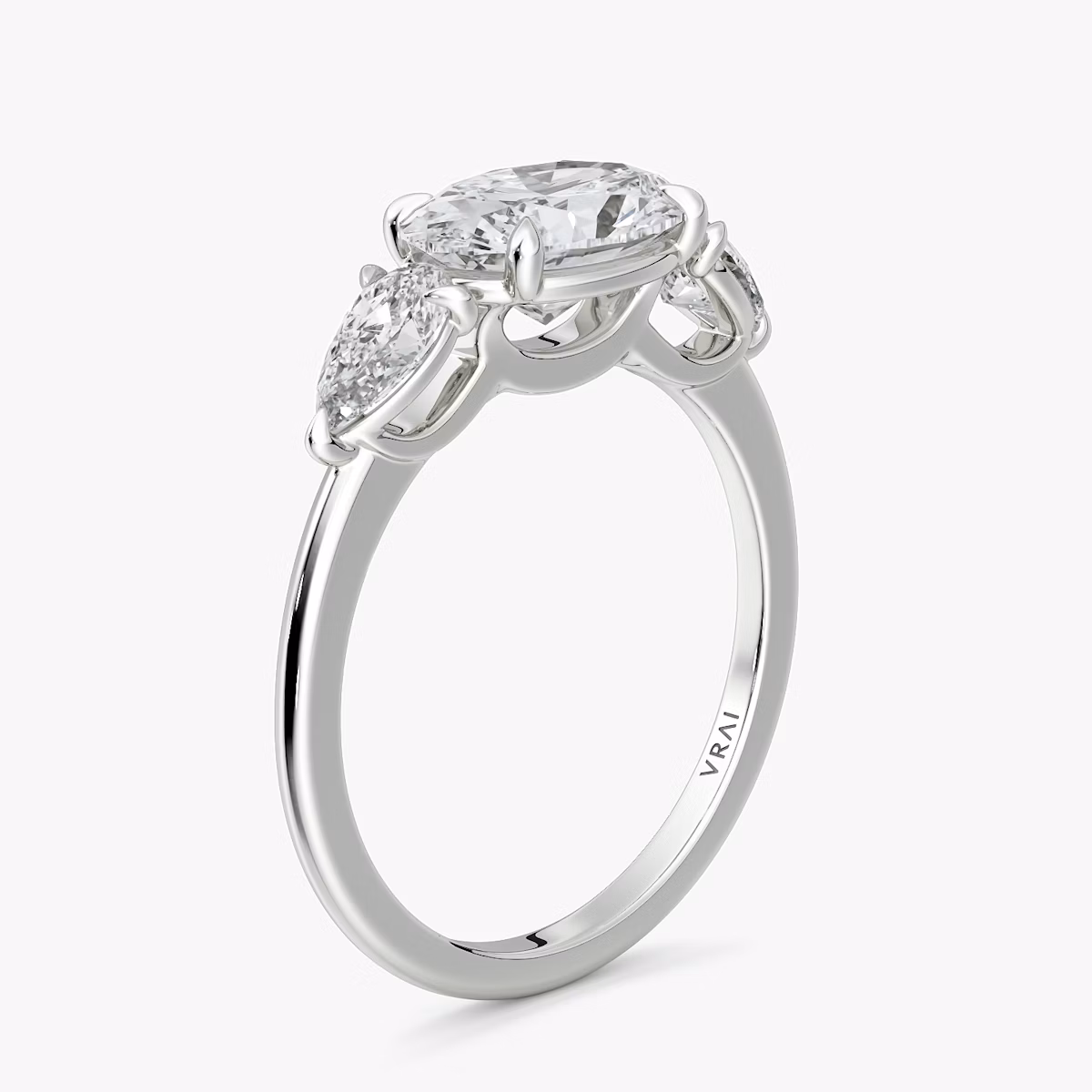 The Three Stone | Oval | Platinum | bandAccent: Plain | diamondOrientation: horizontal | sideStoneCarat: 0.25ct | sideStoneShape: Pear | caratWeight: other