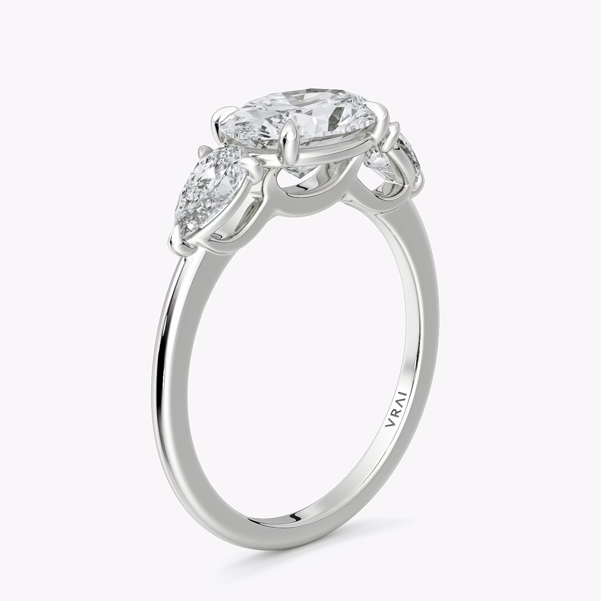 The Three Stone | Oval | 18k | White Gold | bandAccent: Plain | diamondOrientation: horizontal | sideStoneCarat: 0.25ct | sideStoneShape: Pear | caratWeight: other