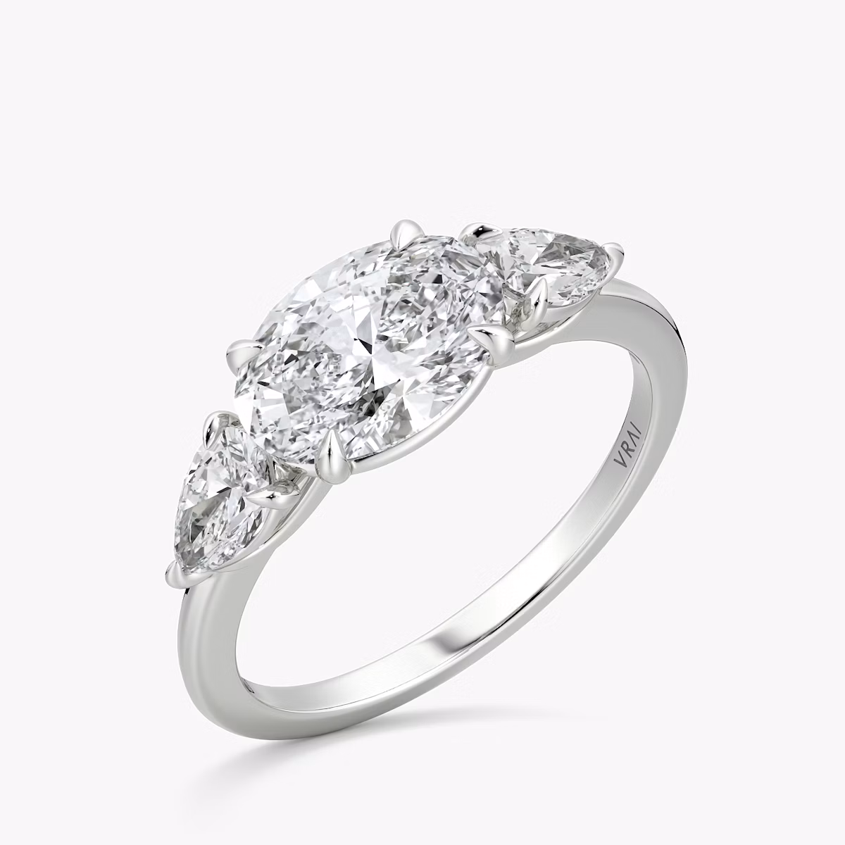 The Three Stone | Oval | Platinum | bandAccent: Plain | diamondOrientation: horizontal | sideStoneCarat: 0.25ct | sideStoneShape: Pear | caratWeight: other