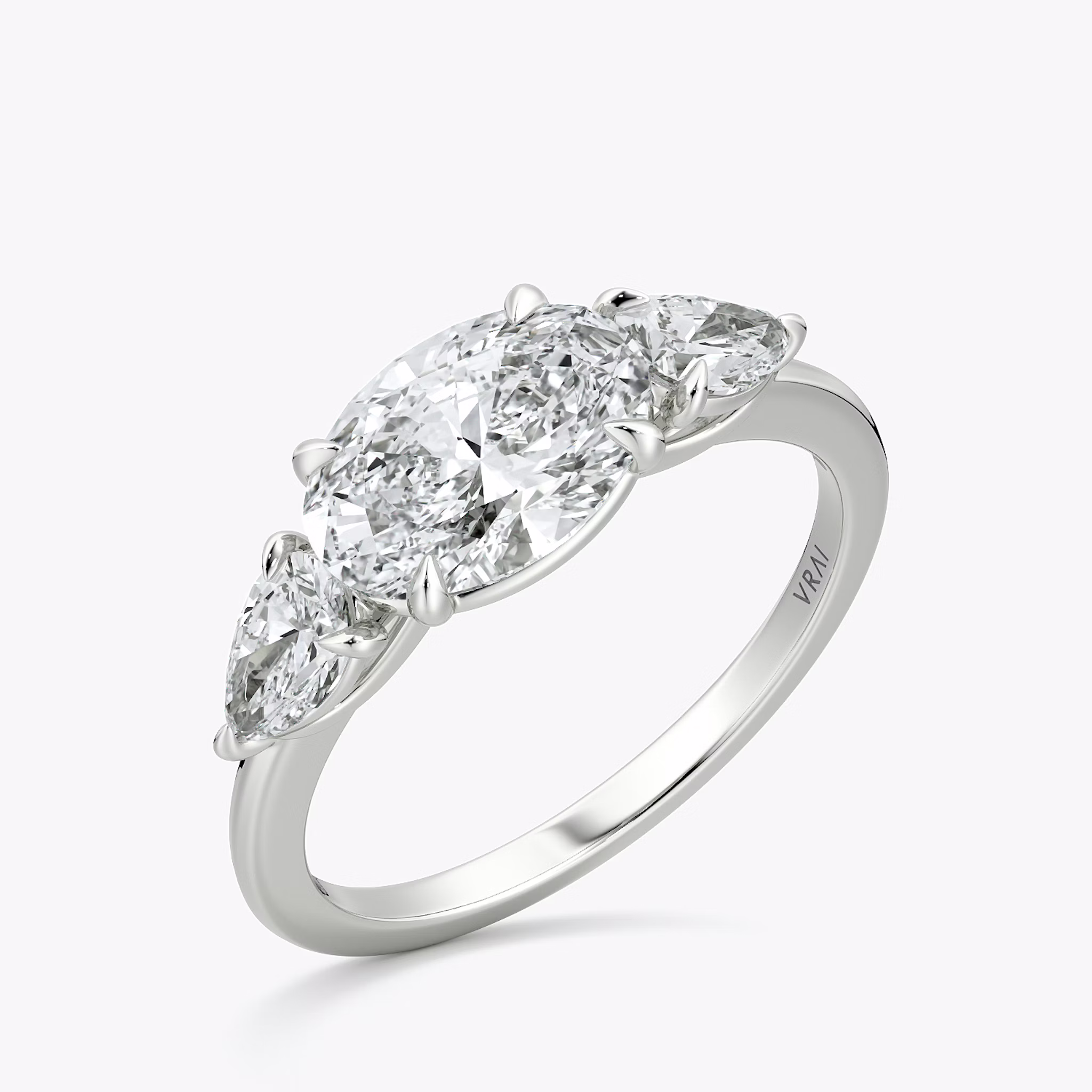The Three Stone | Oval | 18k | White Gold | bandAccent: Plain | diamondOrientation: horizontal | sideStoneCarat: 0.25ct | sideStoneShape: Pear | caratWeight: other