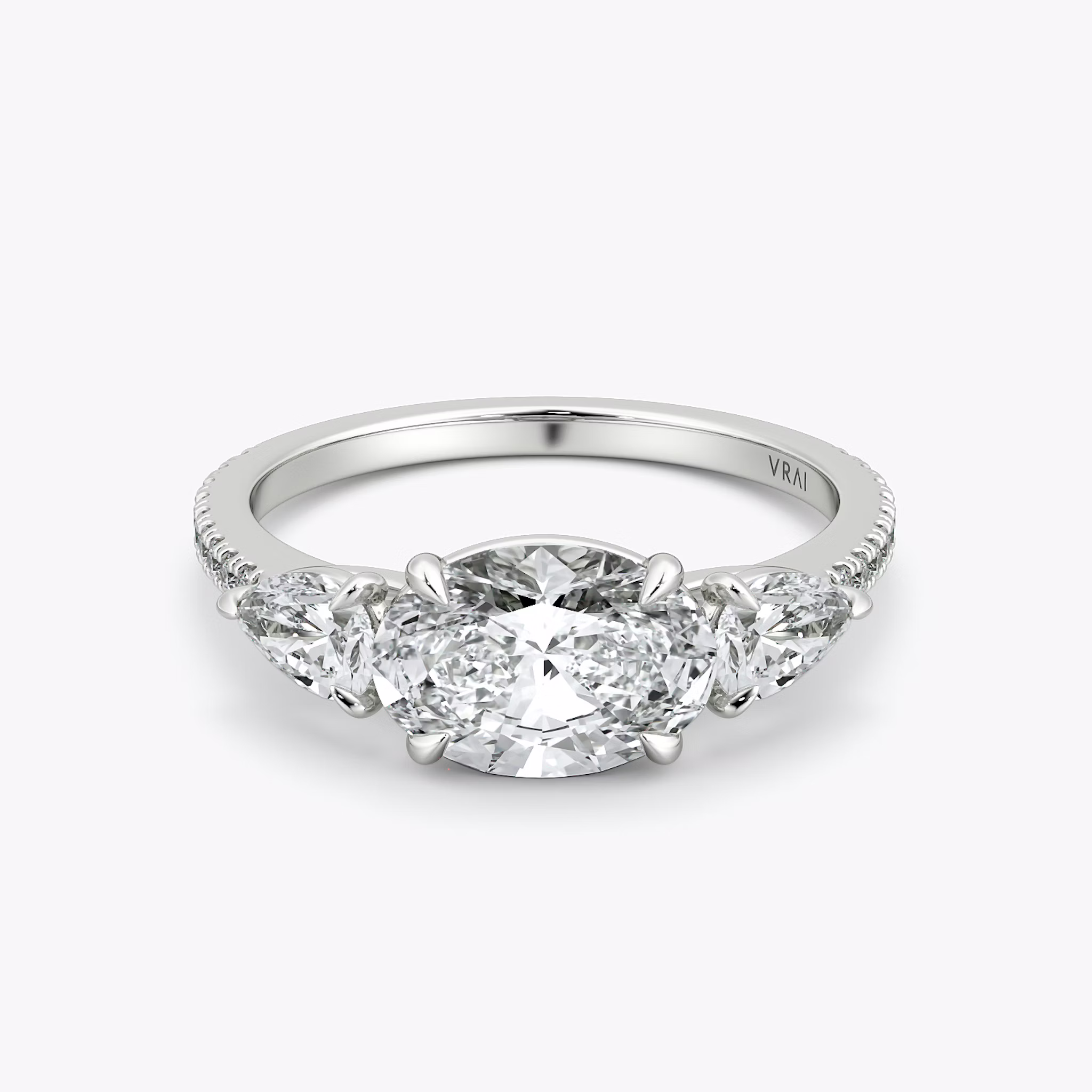 The Three Stone | Oval | 18k | White Gold | bandAccent: Pavé | diamondOrientation: horizontal | sideStoneCarat: 0.25ct | sideStoneShape: Pear | caratWeight: other