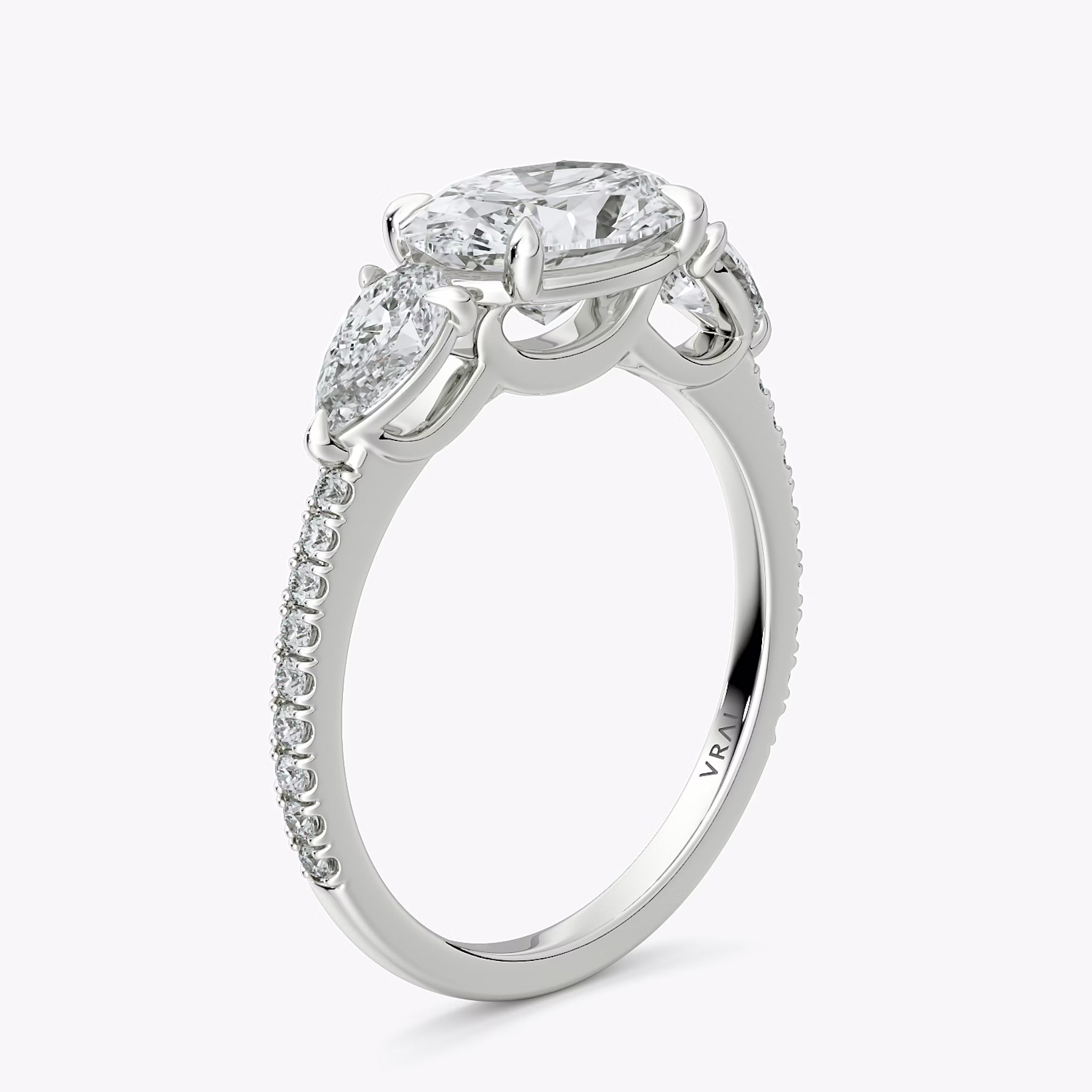 The Three Stone | Oval | 18k | White Gold | bandAccent: Pavé | diamondOrientation: horizontal | sideStoneCarat: 0.25ct | sideStoneShape: Pear | caratWeight: other