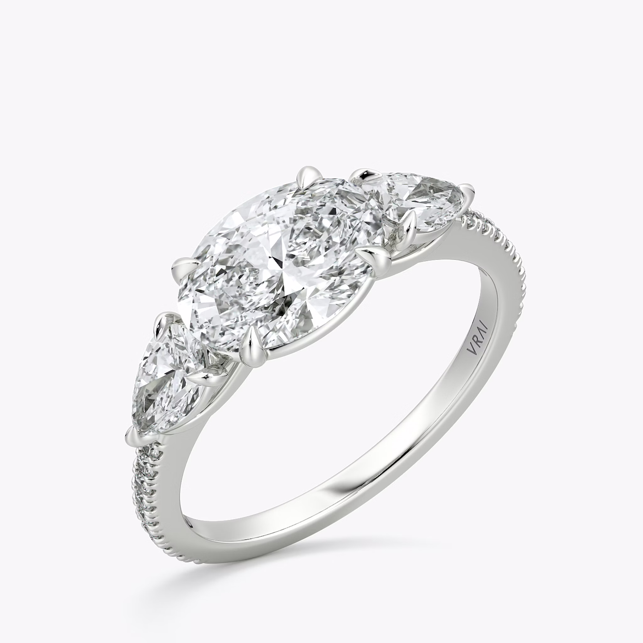 The Three Stone | Oval | 18k | White Gold | bandAccent: Pavé | diamondOrientation: horizontal | sideStoneCarat: 0.25ct | sideStoneShape: Pear | caratWeight: other