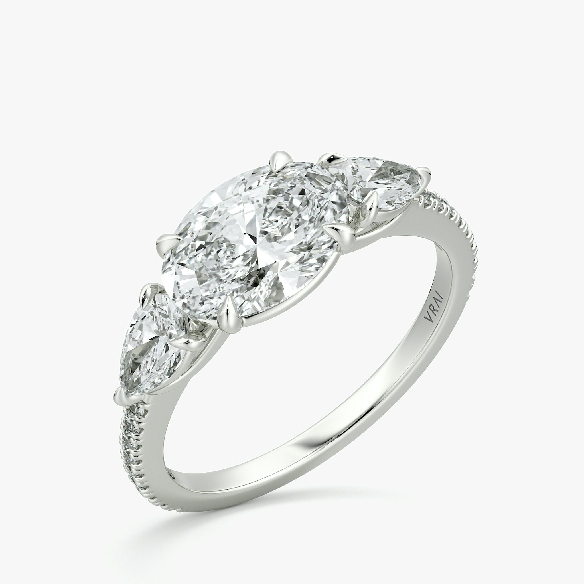 The Three Stone | Oval | 18k | White Gold | bandAccent: Pavé | diamondOrientation: horizontal | sideStoneCarat: 0.25ct | sideStoneShape: Pear | caratWeight: other