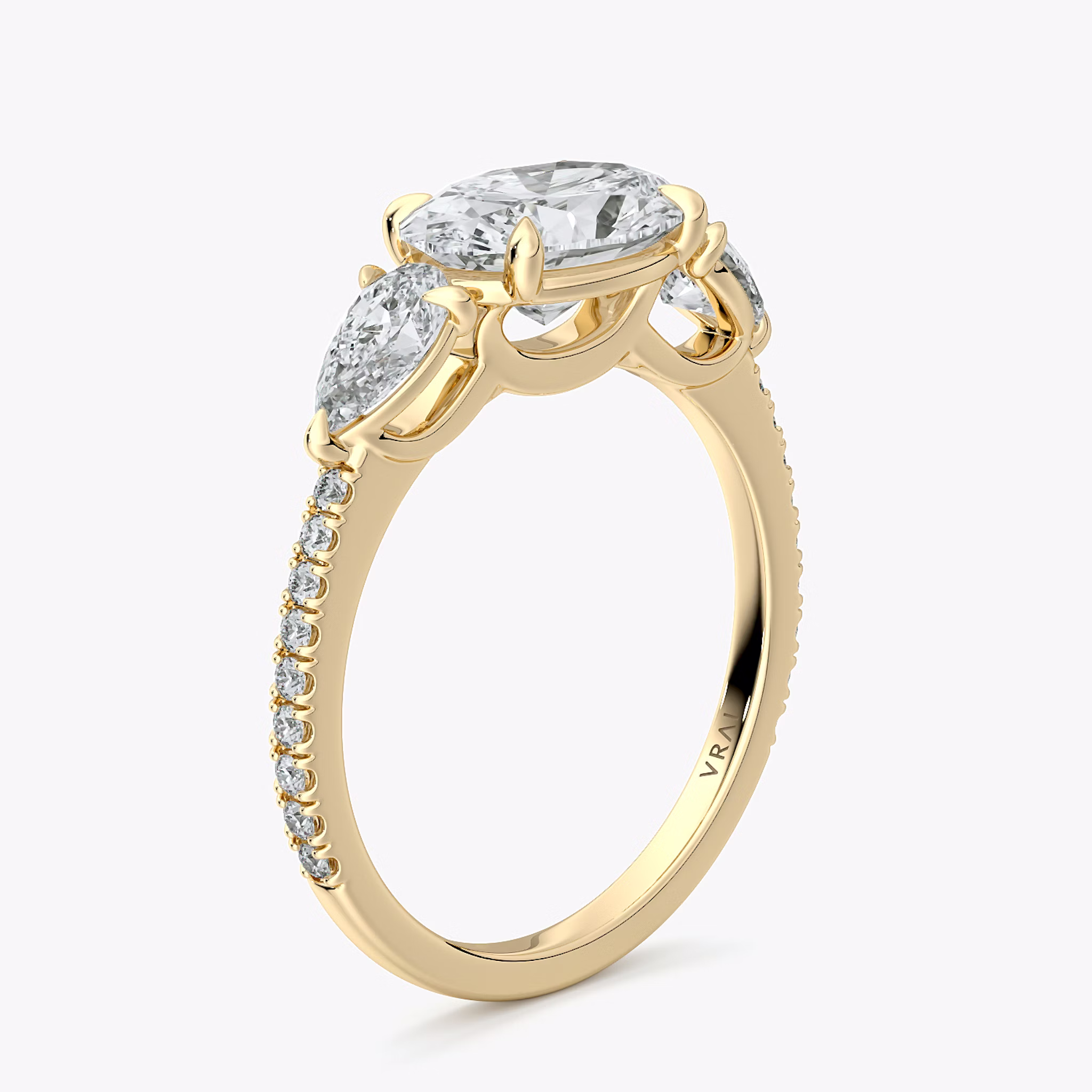The Three Stone | Oval | 18k | Yellow Gold | bandAccent: Pavé | diamondOrientation: horizontal | sideStoneCarat: 0.25ct | sideStoneShape: Pear | caratWeight: other