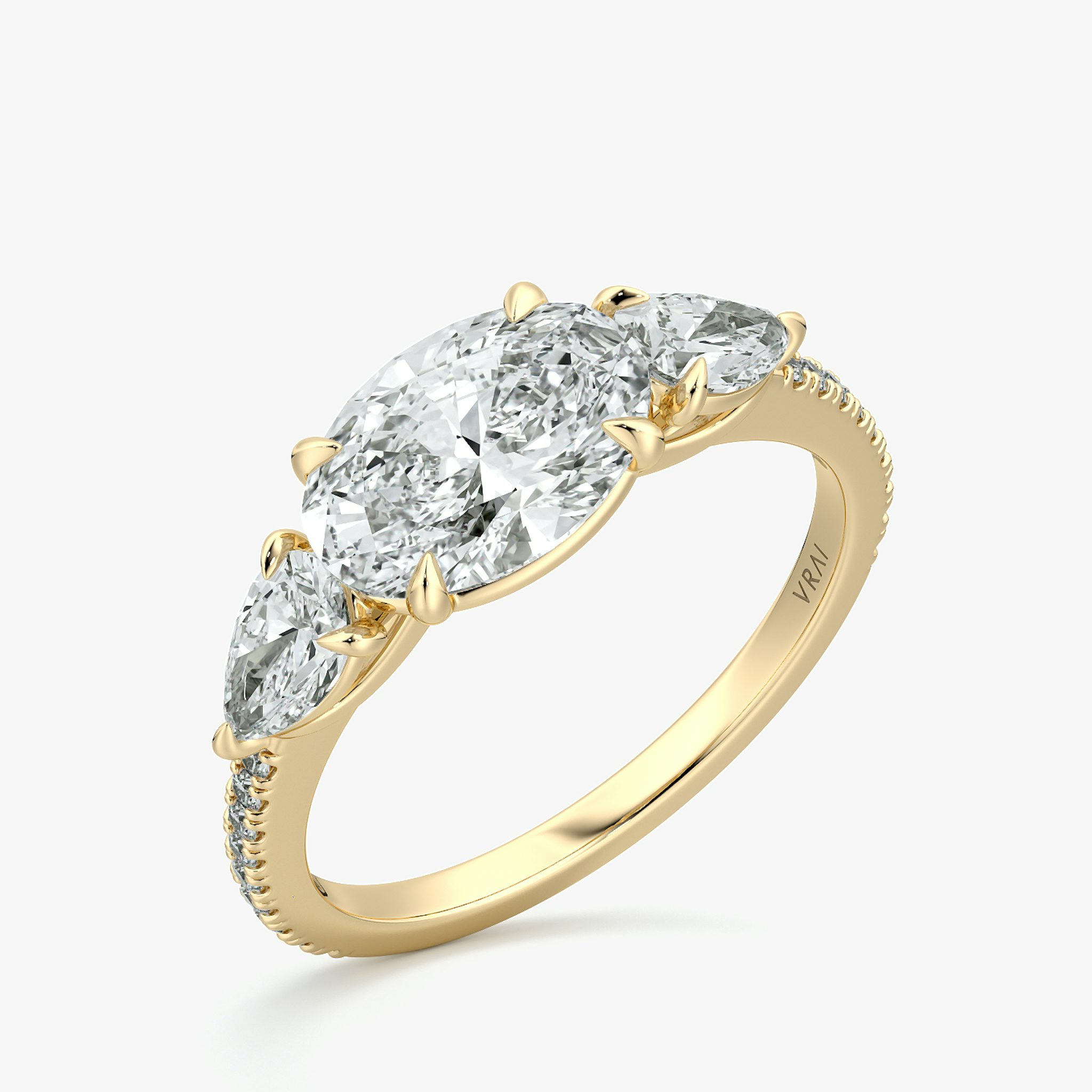The Three Stone | Oval | 18k | Yellow Gold | bandAccent: Pavé | diamondOrientation: horizontal | sideStoneCarat: 0.25ct | sideStoneShape: Pear | caratWeight: other