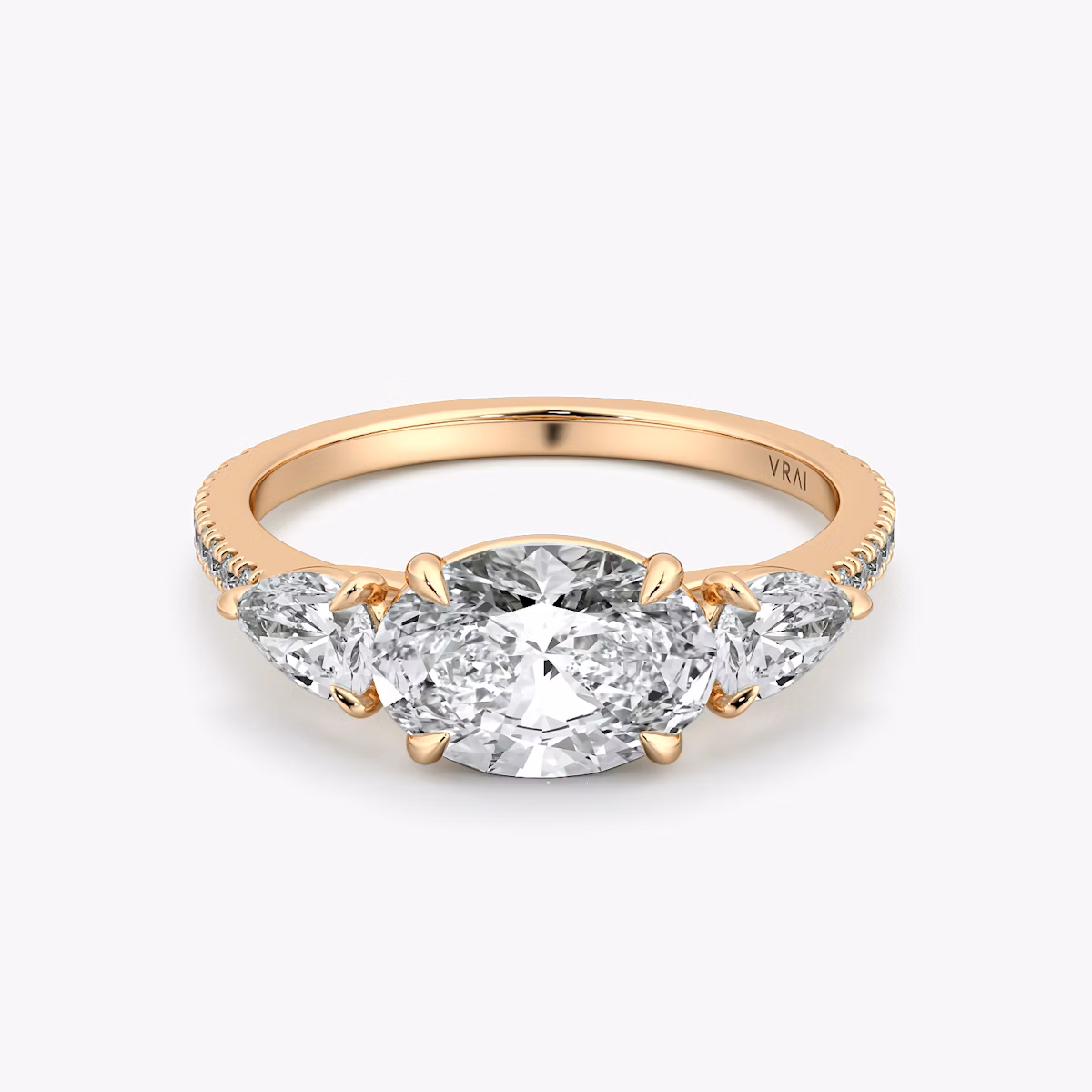The Three Stone | Oval | 14k | Rose Gold | bandAccent: Pavé | diamondOrientation: horizontal | sideStoneCarat: 0.25ct | sideStoneShape: Pear | caratWeight: other