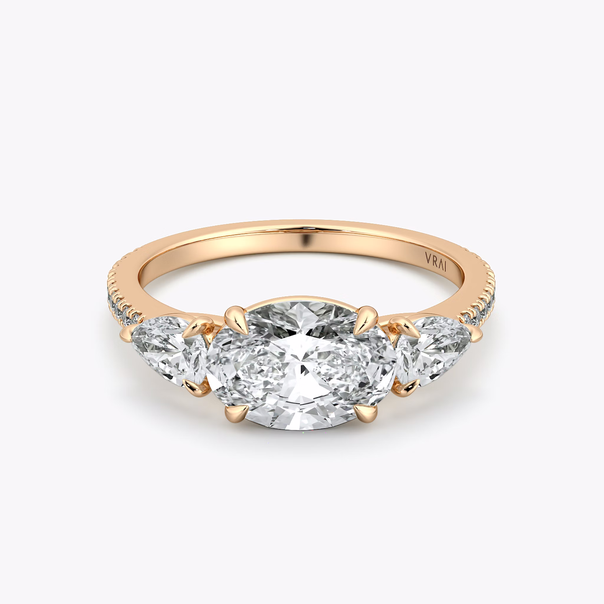 The Three Stone | Oval | 14k | Rose Gold | bandAccent: Pavé | diamondOrientation: horizontal | sideStoneCarat: 0.25ct | sideStoneShape: Pear | caratWeight: other