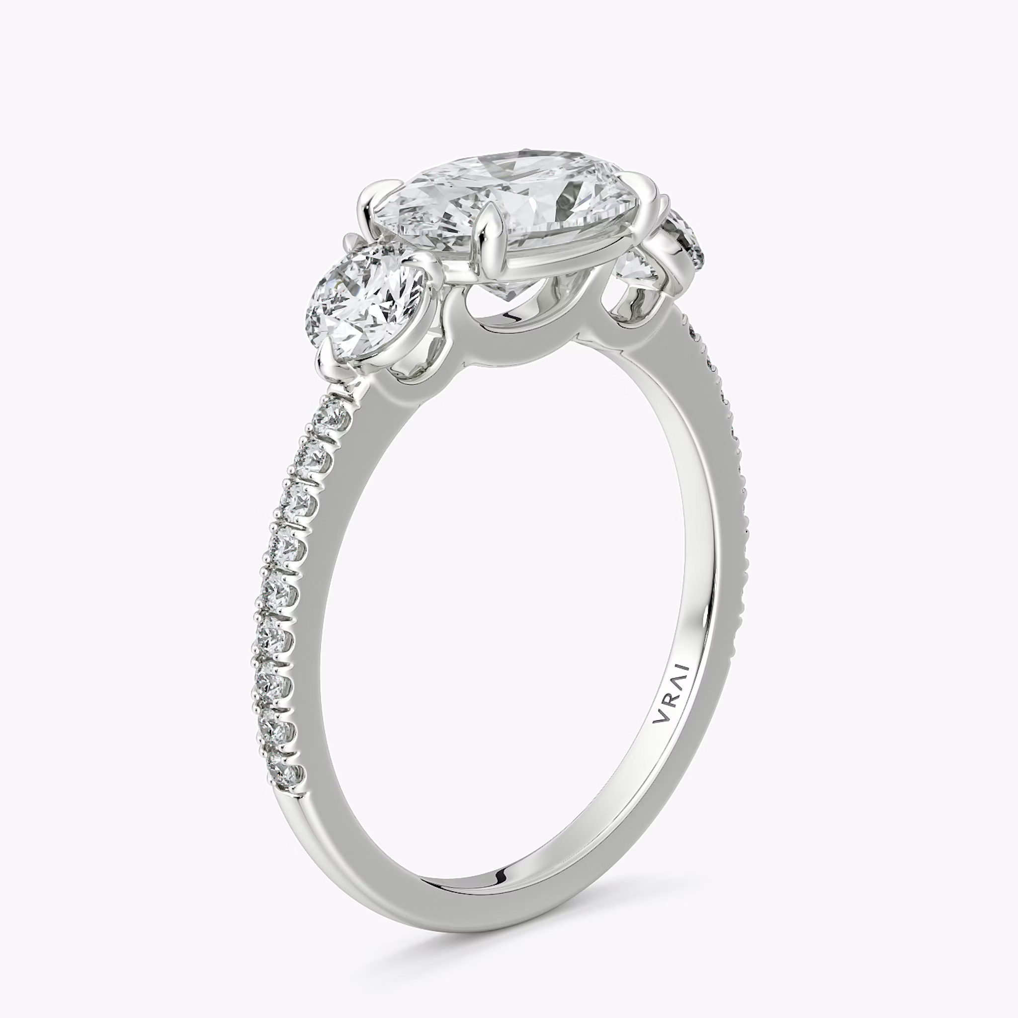 The Three Stone | Oval | 18k | White Gold | bandAccent: Pavé | diamondOrientation: horizontal | sideStoneCarat: 0.25ct | sideStoneShape: Round Brilliant | caratWeight: other