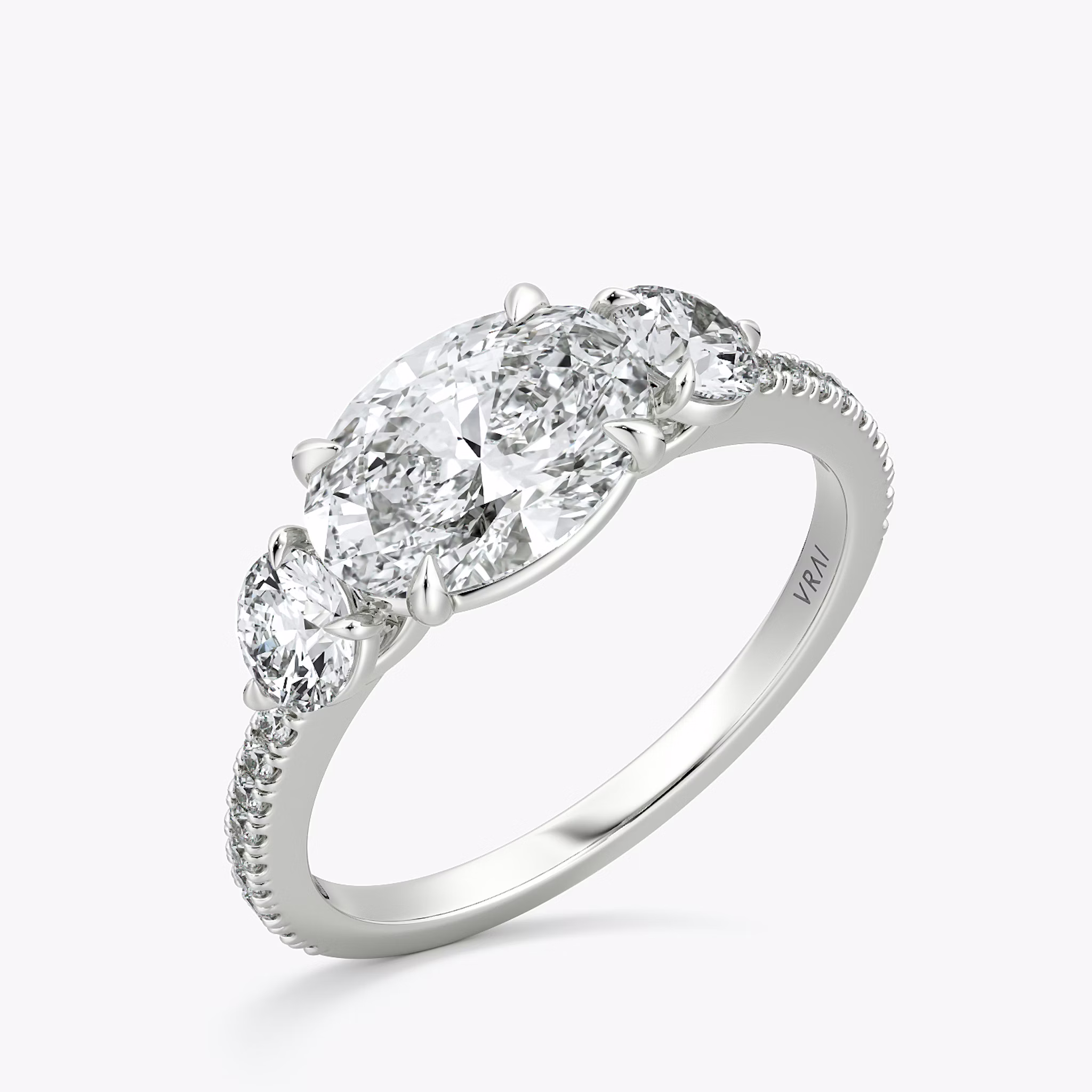 The Three Stone | Oval | 18k | White Gold | bandAccent: Pavé | diamondOrientation: horizontal | sideStoneCarat: 0.25ct | sideStoneShape: Round Brilliant | caratWeight: other