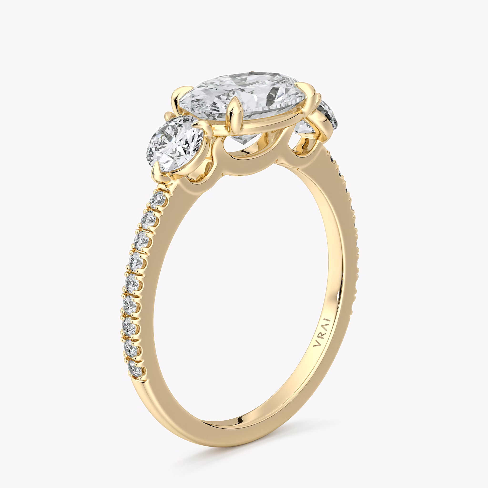 The Three Stone | Oval | 18k | Yellow Gold | bandAccent: Pavé | diamondOrientation: horizontal | sideStoneCarat: 0.25ct | sideStoneShape: Round Brilliant | caratWeight: other