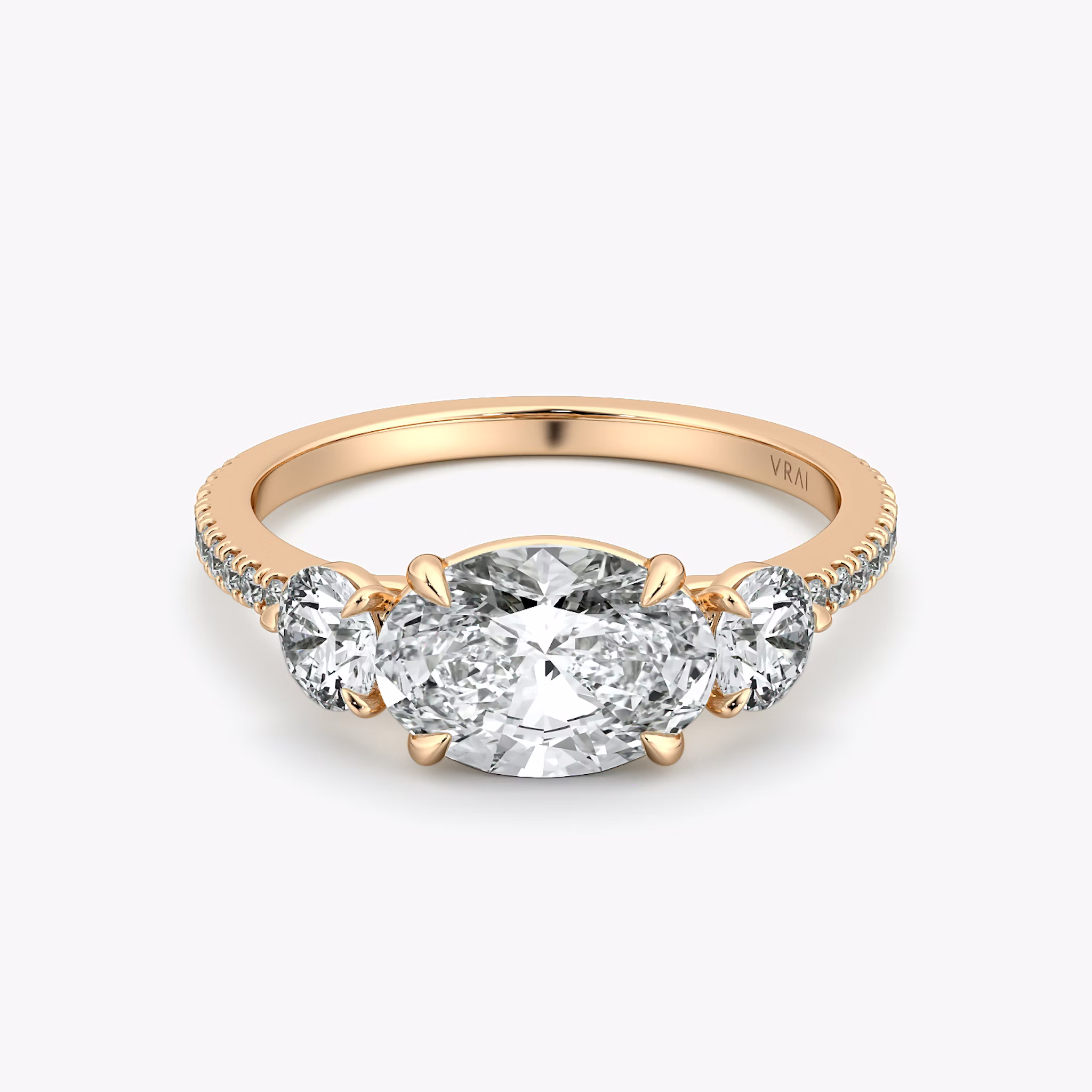 The Three Stone | Oval | 14k | Rose Gold | bandAccent: Pavé | diamondOrientation: horizontal | sideStoneCarat: 0.25ct | sideStoneShape: Round Brilliant | caratWeight: other