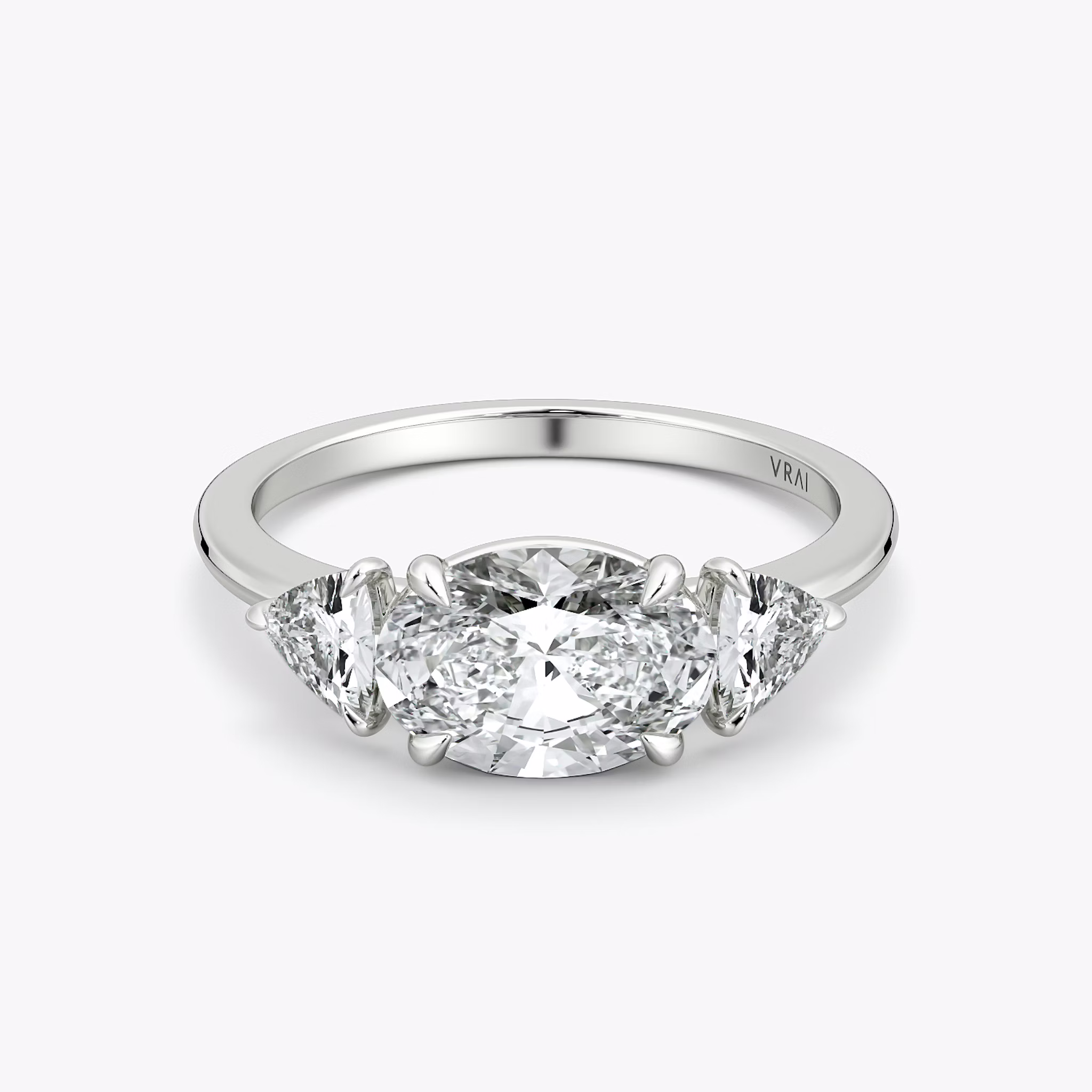 The Three Stone | Oval | 18k | White Gold | bandAccent: Plain | diamondOrientation: horizontal | sideStoneCarat: 0.25ct | sideStoneShape: Trillion | caratWeight: other