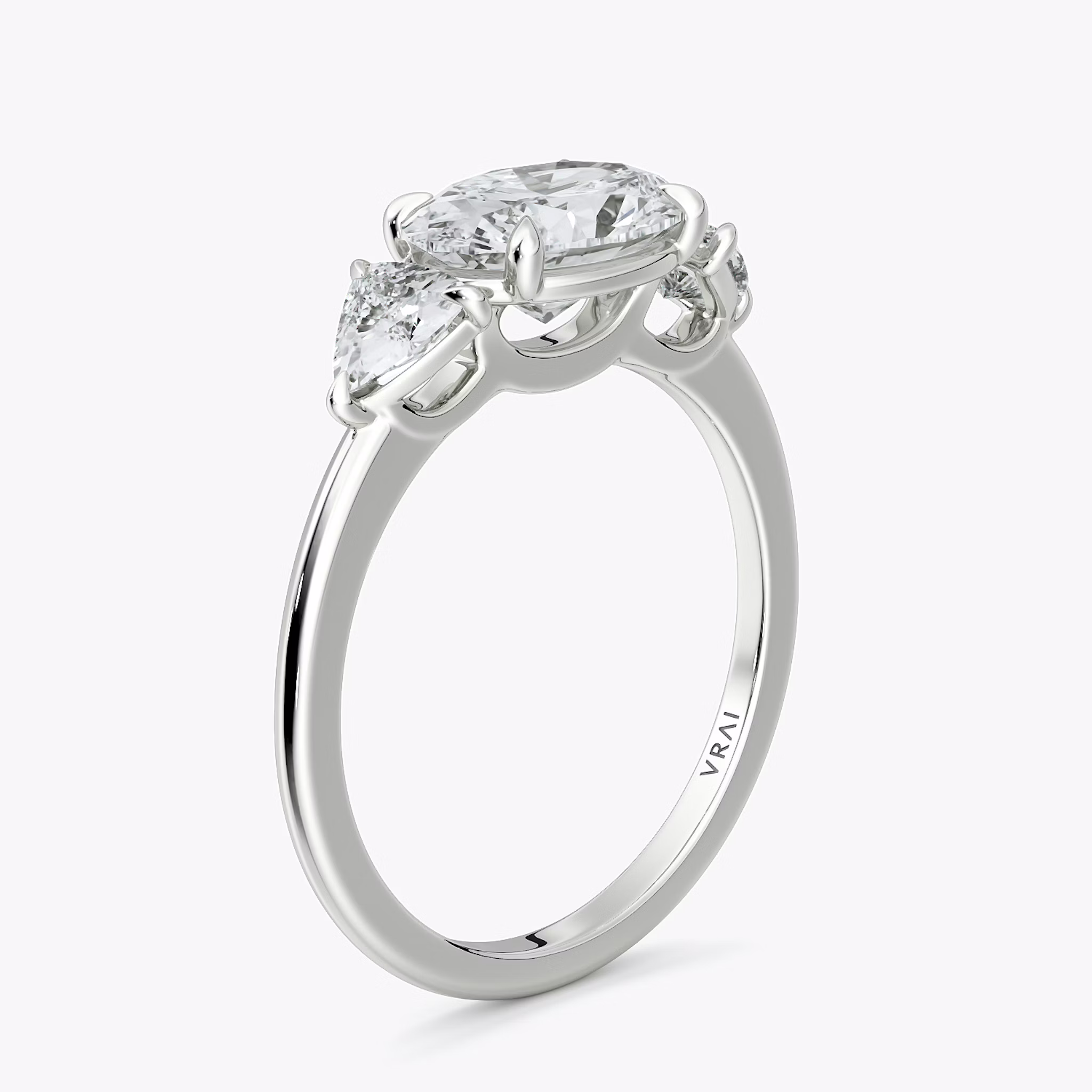 The Three Stone | Oval | 18k | White Gold | bandAccent: Plain | diamondOrientation: horizontal | sideStoneCarat: 0.25ct | sideStoneShape: Trillion | caratWeight: other