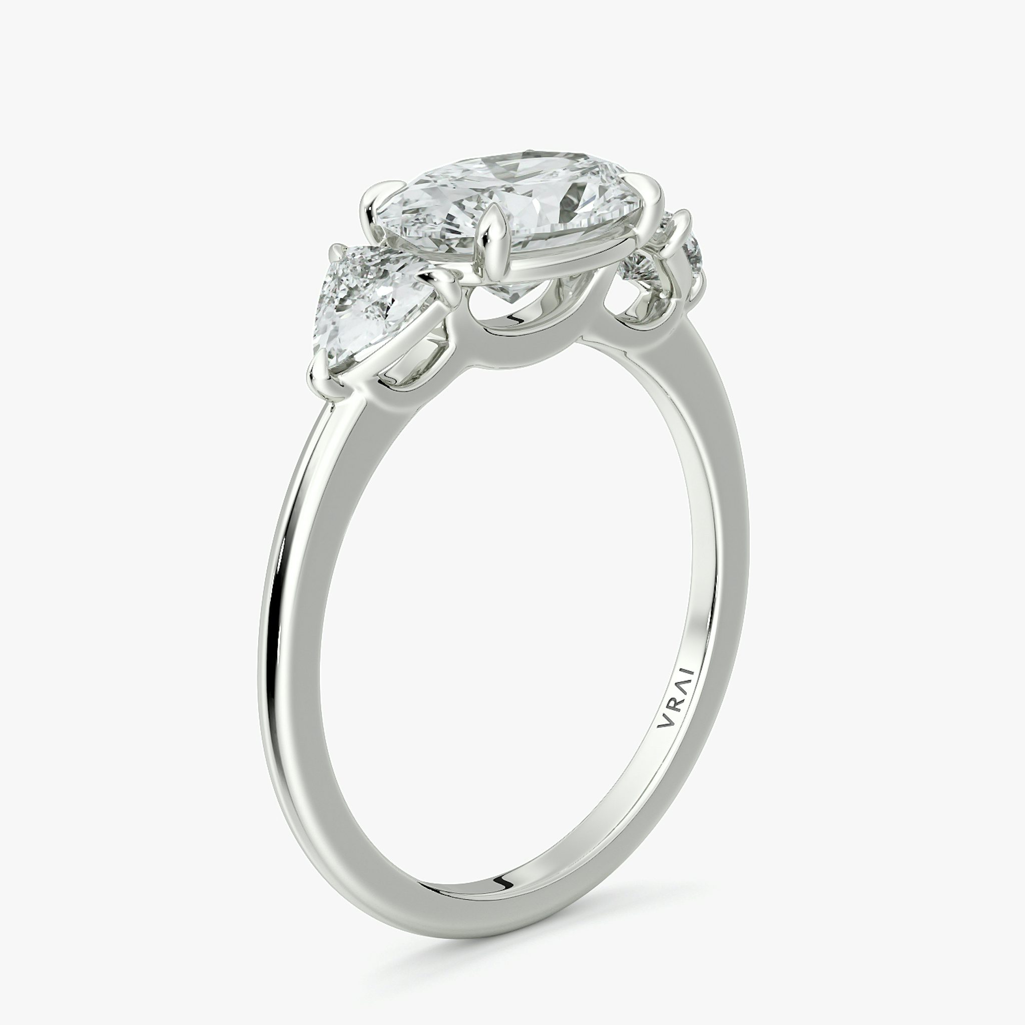 The Three Stone | Oval | 18k | White Gold | bandAccent: Plain | diamondOrientation: horizontal | sideStoneCarat: 0.25ct | sideStoneShape: Trillion | caratWeight: other