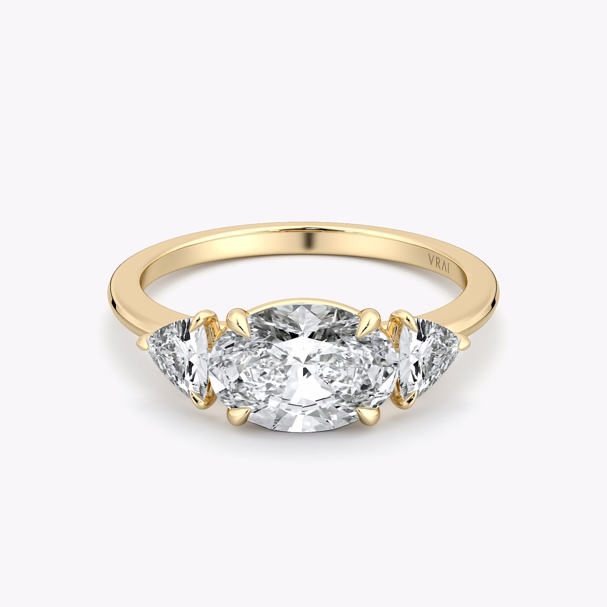 The Three Stone | Oval | 18k | Yellow Gold | bandAccent: Plain | diamondOrientation: horizontal | sideStoneCarat: 0.25ct | sideStoneShape: Trillion | caratWeight: other