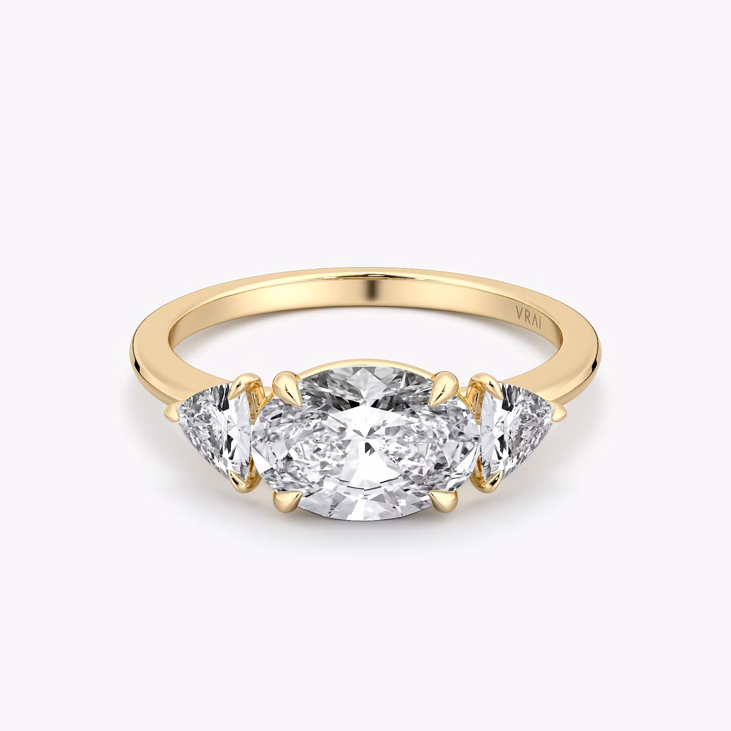 The Three Stone | Oval | 18k | Yellow Gold | bandAccent: Plain | diamondOrientation: horizontal | sideStoneCarat: 0.25ct | sideStoneShape: Trillion | caratWeight: other
