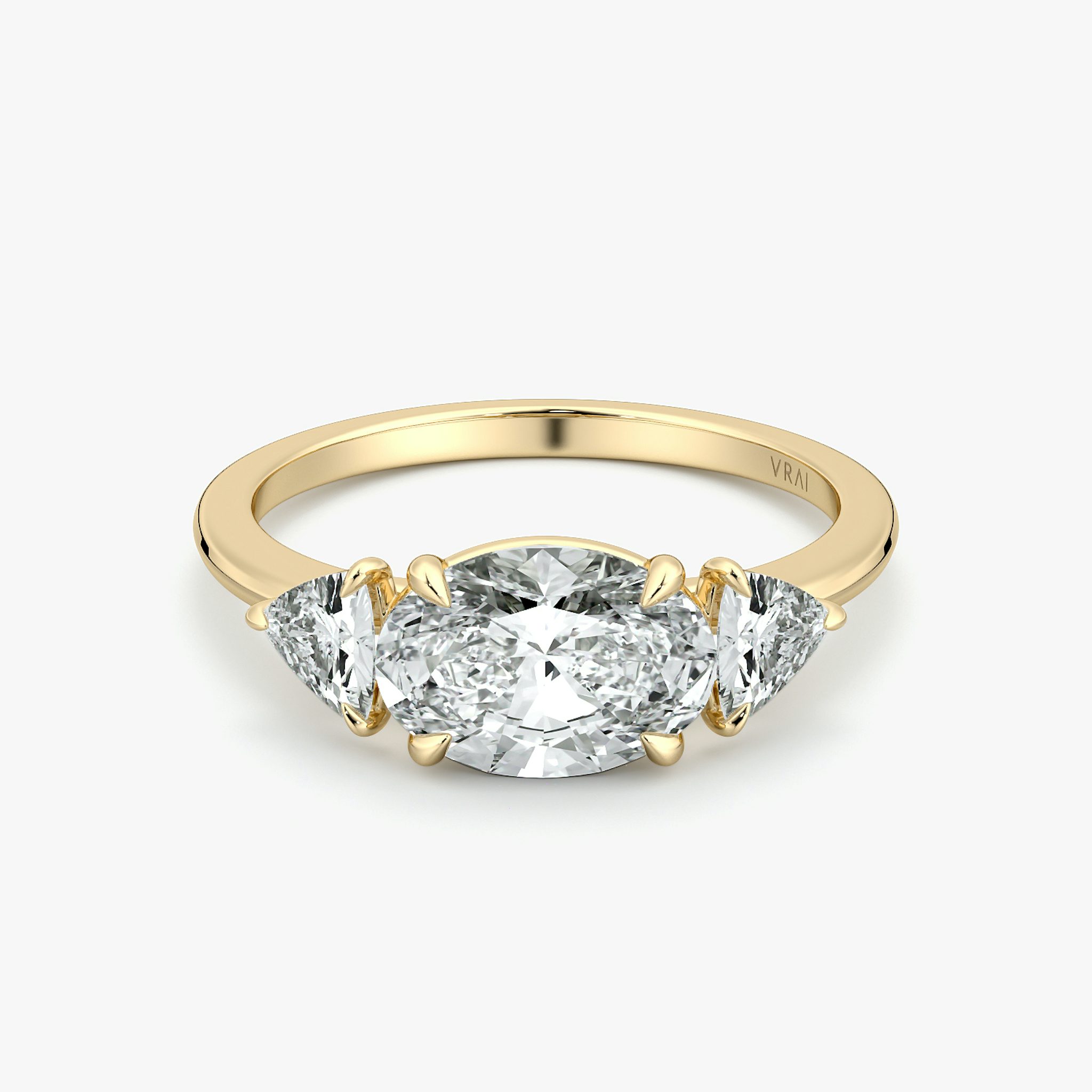 The Three Stone | Oval | 18k | Yellow Gold | bandAccent: Plain | diamondOrientation: horizontal | sideStoneCarat: 0.25ct | sideStoneShape: Trillion | caratWeight: other