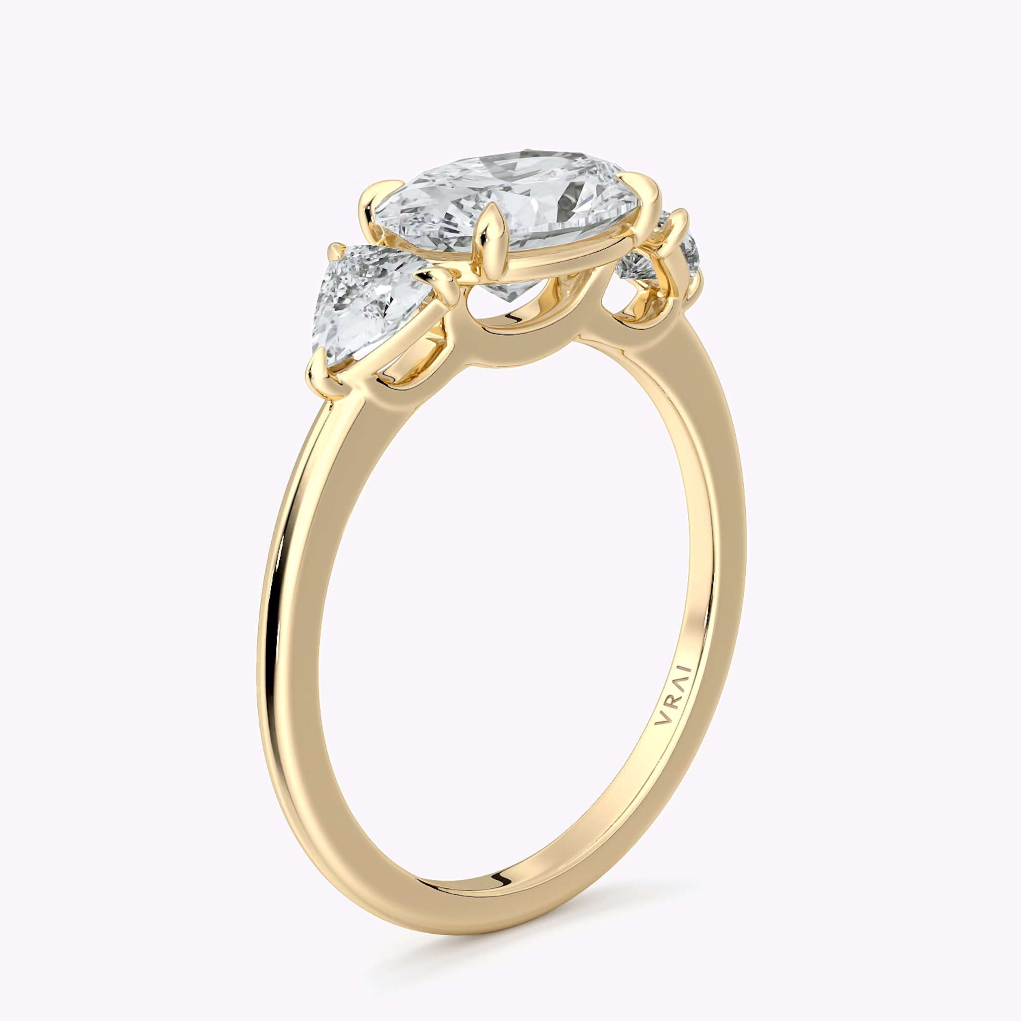 The Three Stone | Oval | 18k | Yellow Gold | bandAccent: Plain | diamondOrientation: horizontal | sideStoneCarat: 0.25ct | sideStoneShape: Trillion | caratWeight: other
