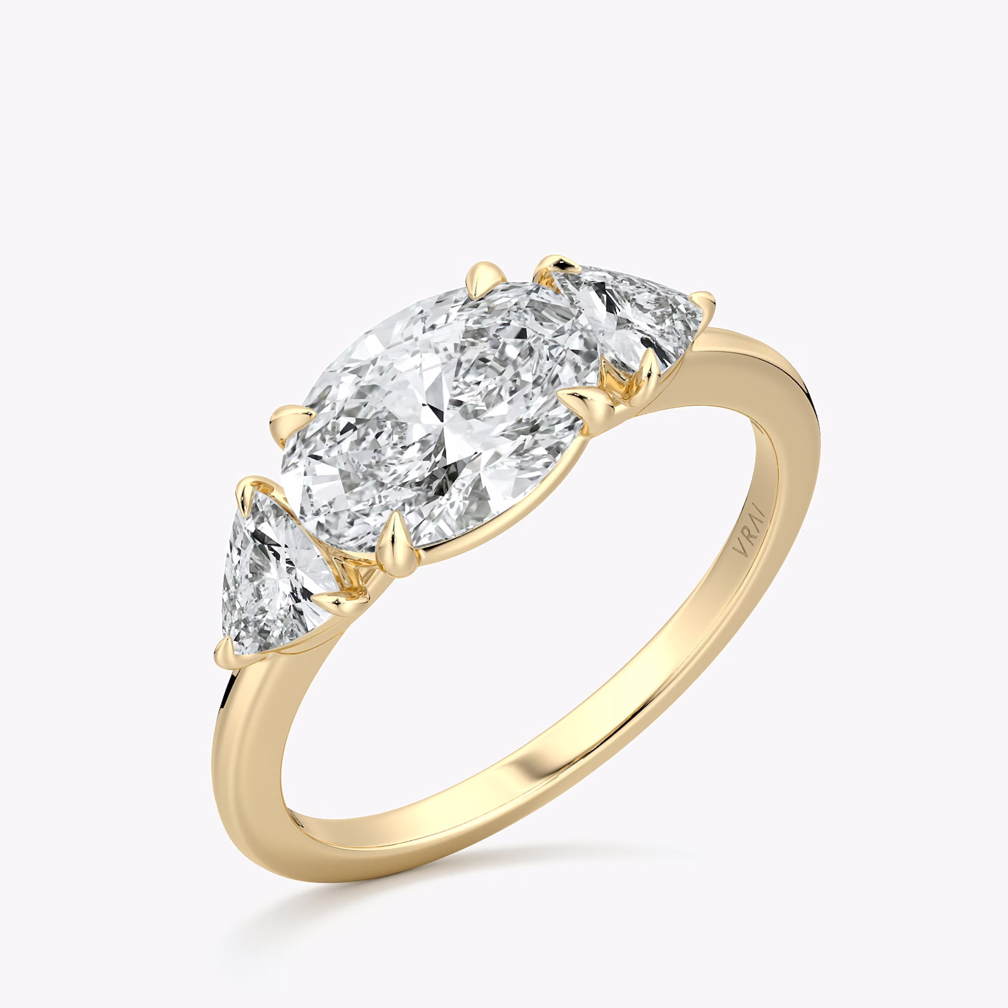 The Three Stone | Oval | 18k | Yellow Gold | bandAccent: Plain | diamondOrientation: horizontal | sideStoneCarat: 0.25ct | sideStoneShape: Trillion | caratWeight: other