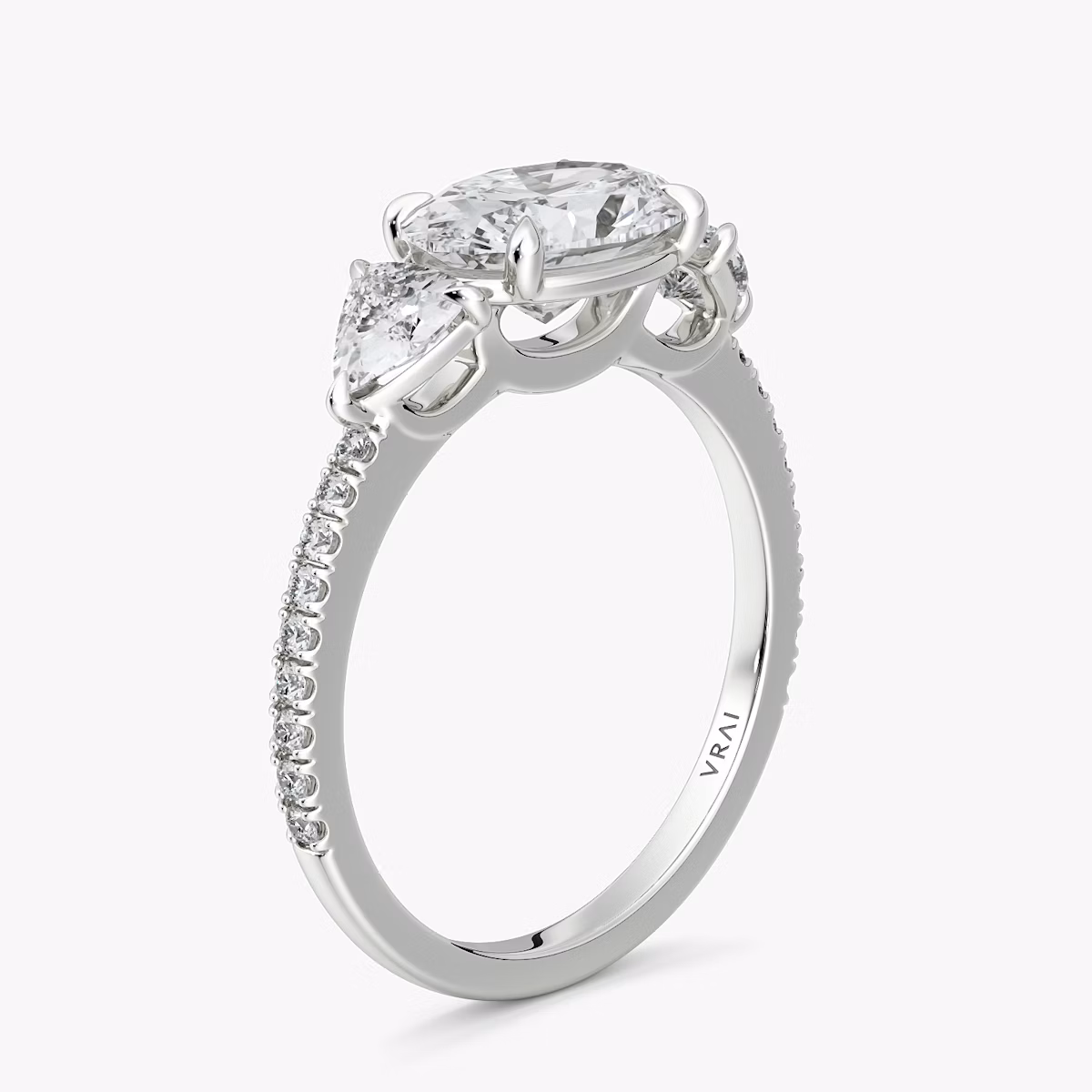 The Three Stone | Oval | 18k | White Gold | bandAccent: Pavé | diamondOrientation: horizontal | sideStoneCarat: 0.25ct | sideStoneShape: Trillion | caratWeight: other
