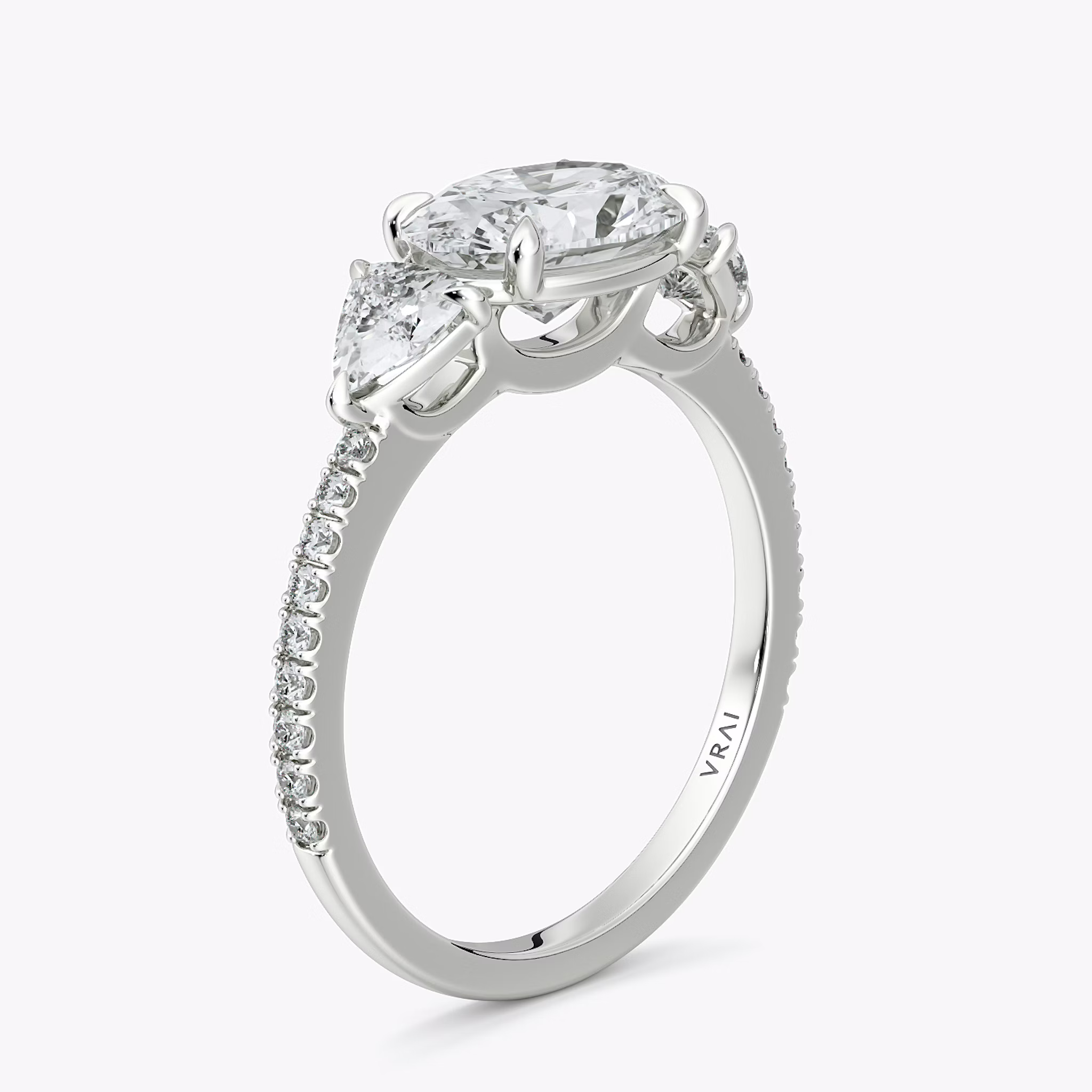 The Three Stone | Oval | Platinum | bandAccent: Pavé | diamondOrientation: horizontal | sideStoneCarat: 0.25ct | sideStoneShape: Trillion | caratWeight: other
