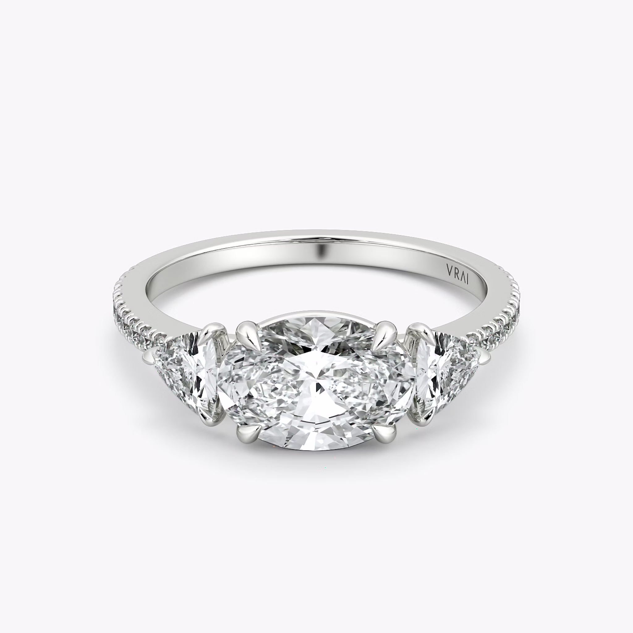 The Three Stone | Oval | Platinum | bandAccent: Pavé | diamondOrientation: horizontal | sideStoneCarat: 0.25ct | sideStoneShape: Trillion | caratWeight: other