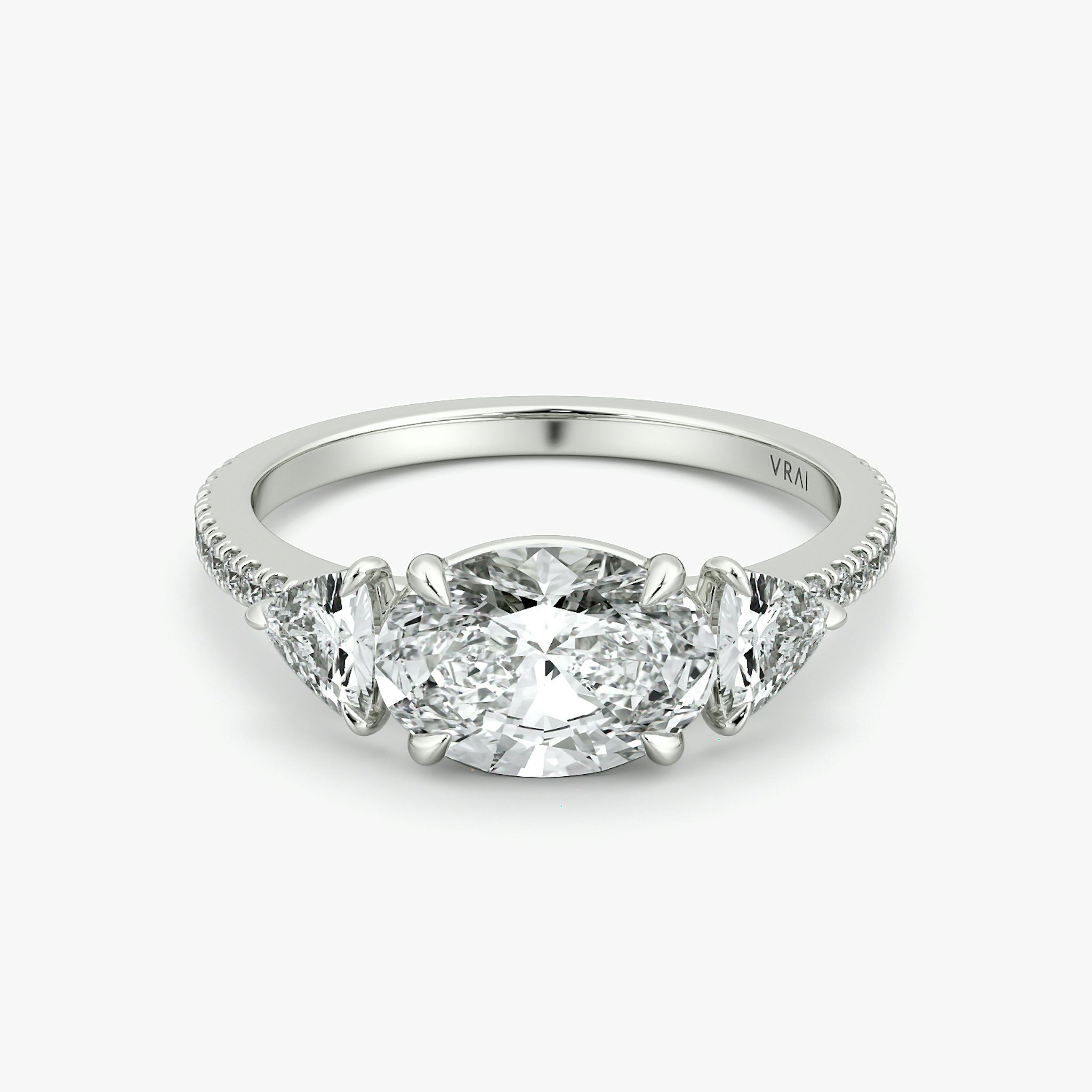 The Three Stone | Oval | Platinum | bandAccent: Pavé | diamondOrientation: horizontal | sideStoneCarat: 0.25ct | sideStoneShape: Trillion | caratWeight: other