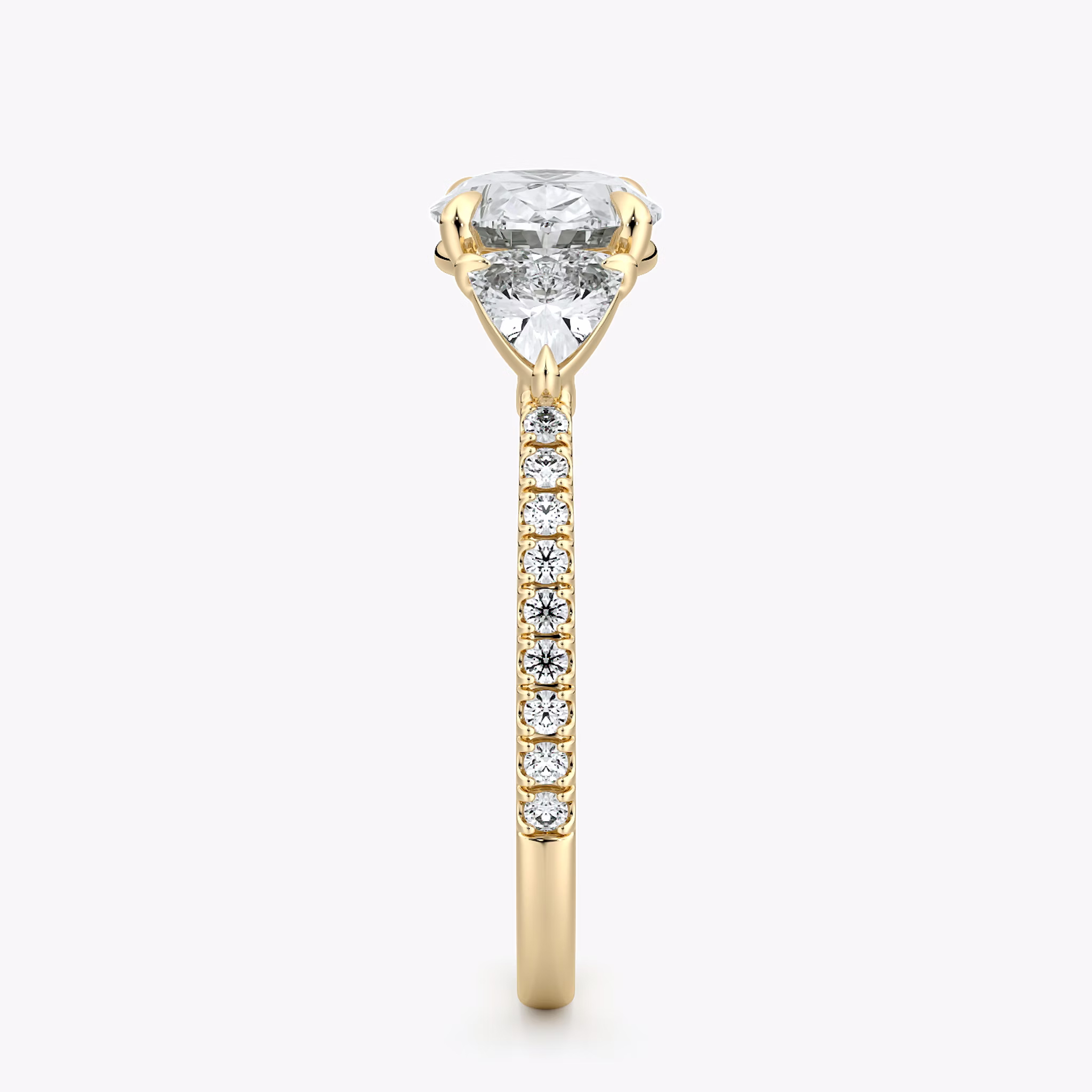The Three Stone | Oval | 18k | Yellow Gold | bandAccent: Pavé | diamondOrientation: horizontal | sideStoneCarat: 0.25ct | sideStoneShape: Trillion | caratWeight: other