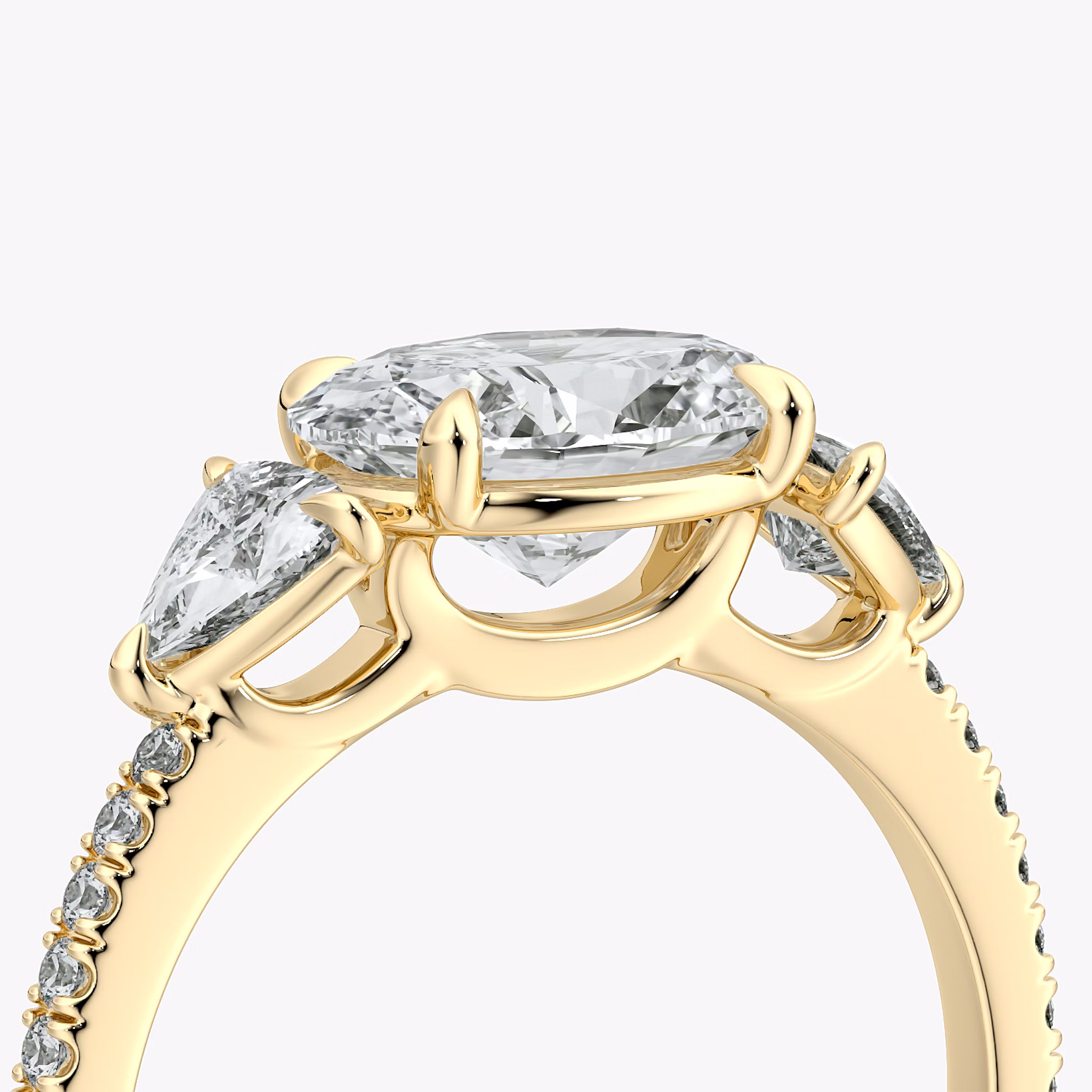 The Three Stone | Oval | 18k | Yellow Gold | bandAccent: Pavé | diamondOrientation: horizontal | sideStoneCarat: 0.25ct | sideStoneShape: Trillion | caratWeight: other