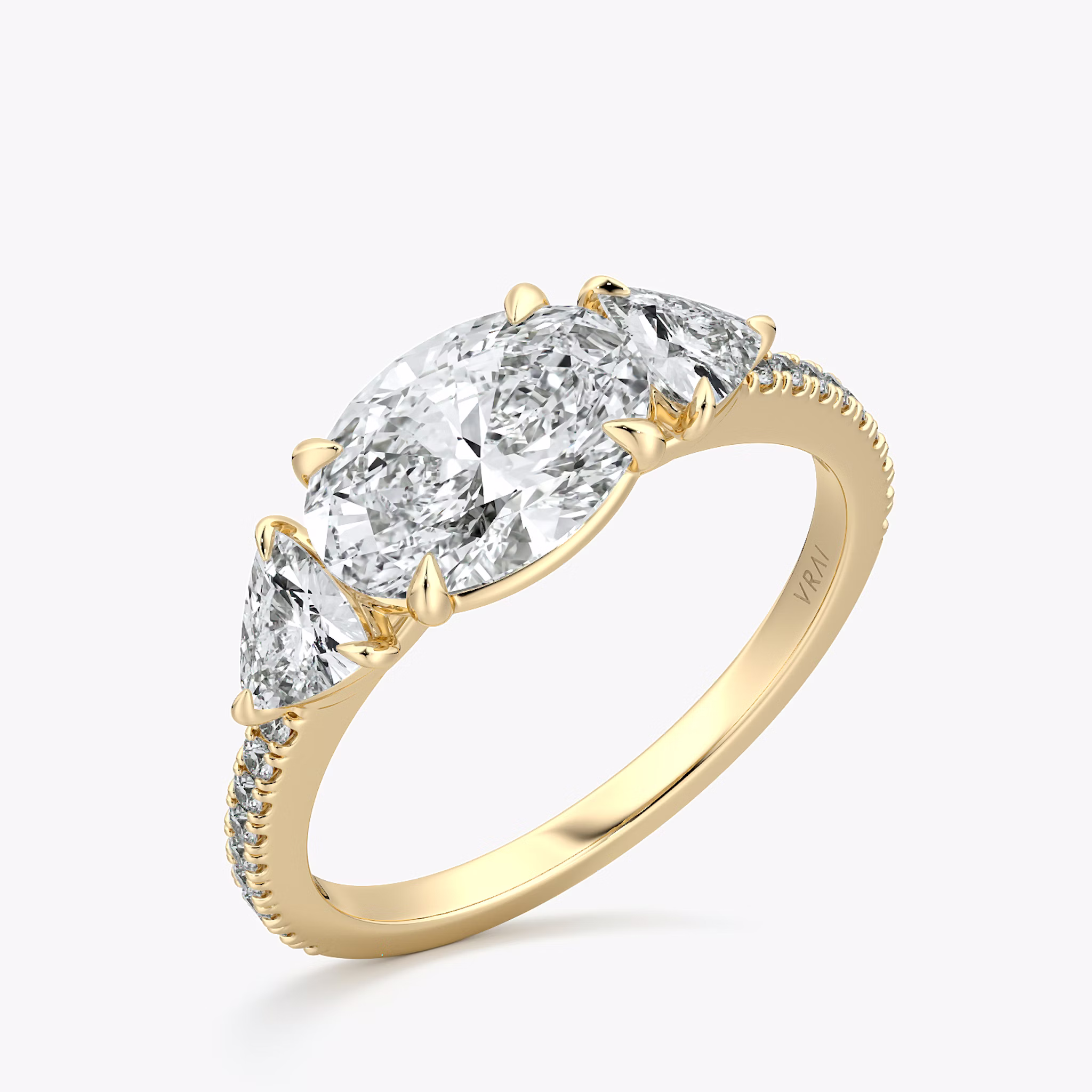 The Three Stone | Oval | 18k | Yellow Gold | bandAccent: Pavé | diamondOrientation: horizontal | sideStoneCarat: 0.25ct | sideStoneShape: Trillion | caratWeight: other