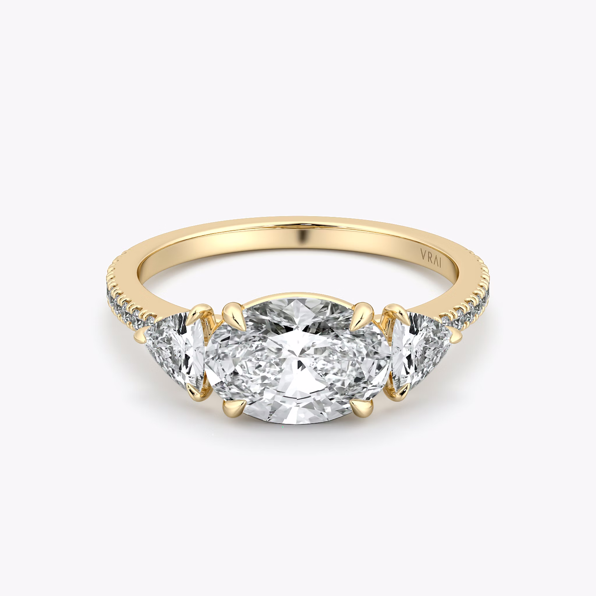 The Three Stone | Oval | 18k | Yellow Gold | bandAccent: Pavé | diamondOrientation: horizontal | sideStoneCarat: 0.25ct | sideStoneShape: Trillion | caratWeight: other