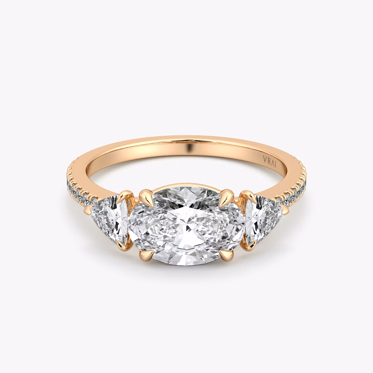 The Three Stone | Oval | 14k | Rose Gold | bandAccent: Pavé | diamondOrientation: horizontal | sideStoneCarat: 0.25ct | sideStoneShape: Trillion | caratWeight: other