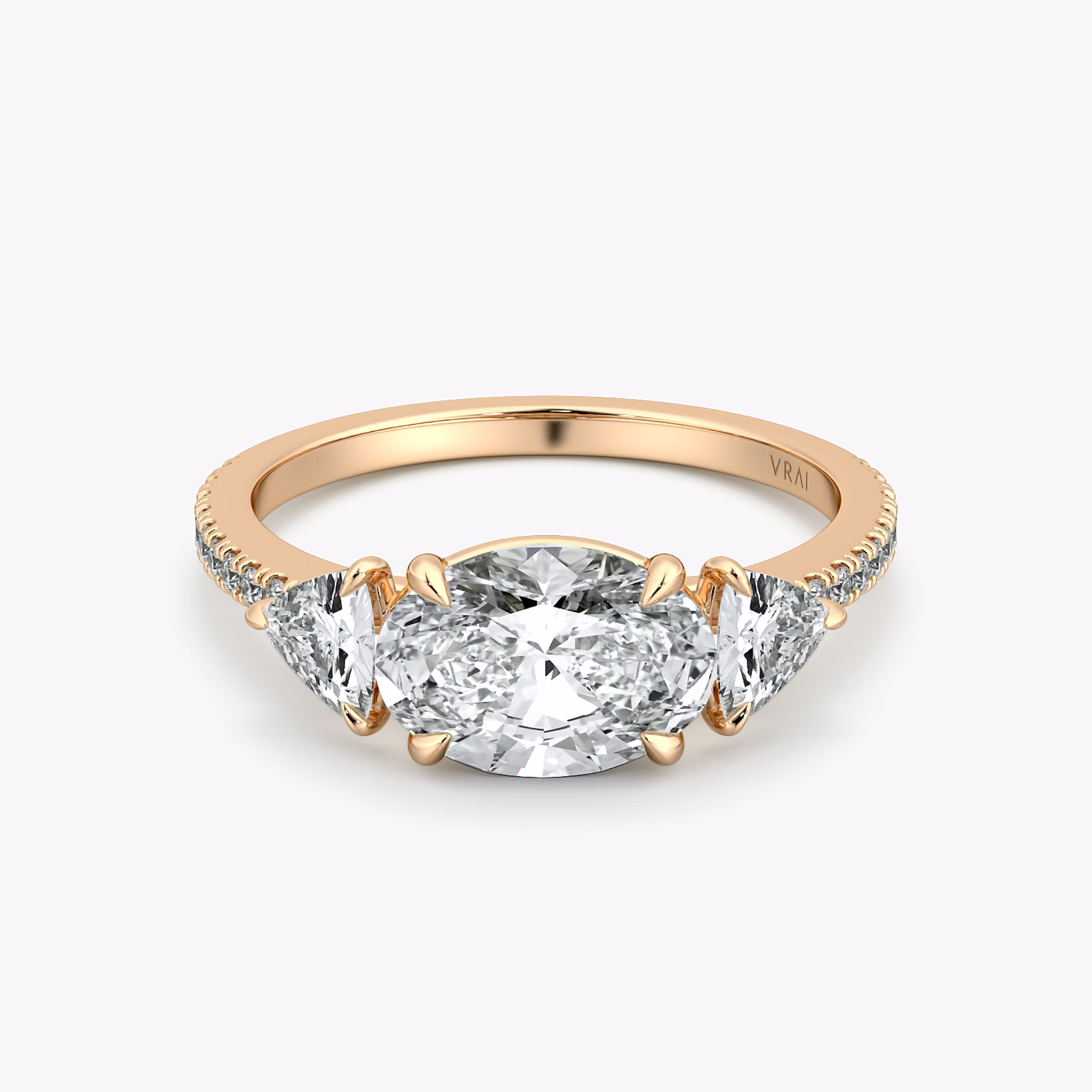 The Three Stone | Oval | 14k | Rose Gold | bandAccent: Pavé | diamondOrientation: horizontal | sideStoneCarat: 0.25ct | sideStoneShape: Trillion | caratWeight: other