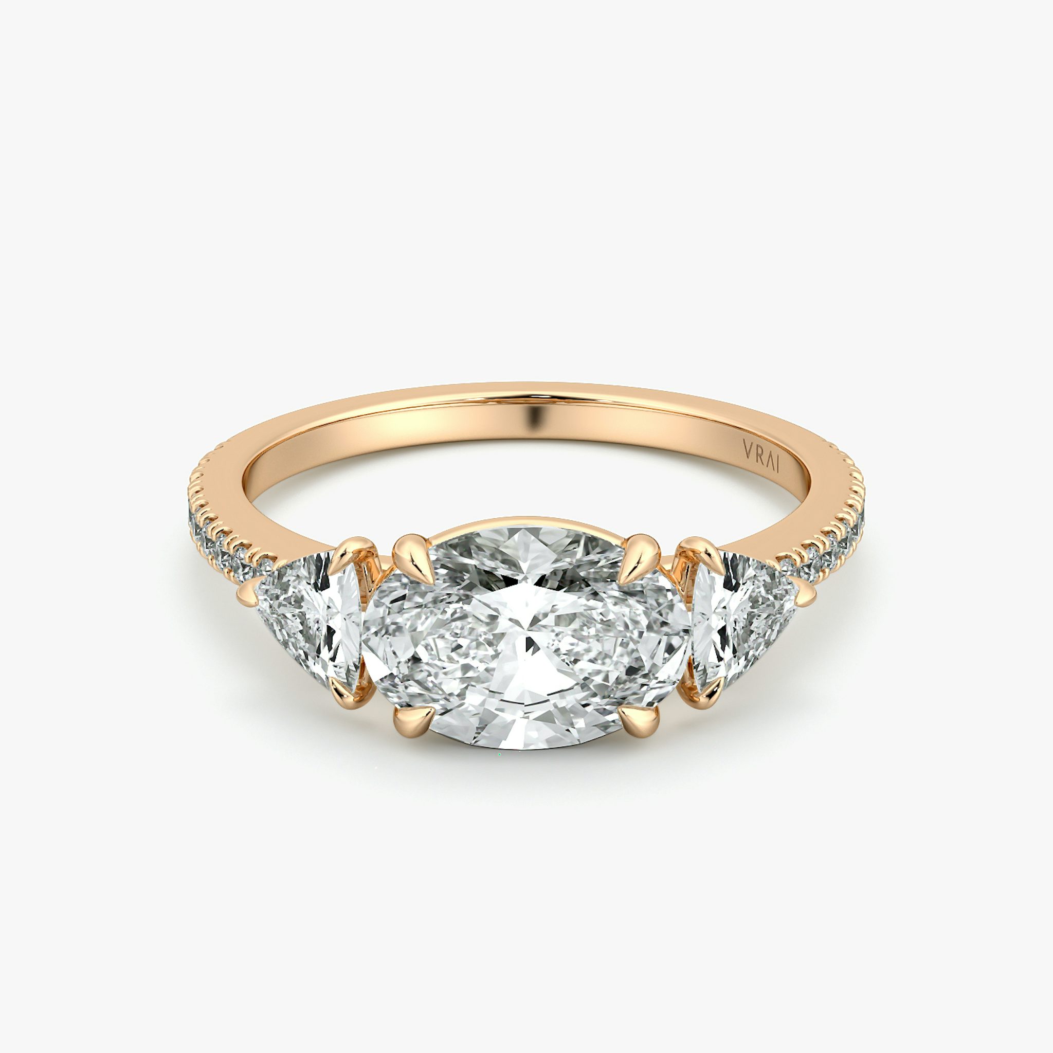 The Three Stone | Oval | 14k | Rose Gold | bandAccent: Pavé | diamondOrientation: horizontal | sideStoneCarat: 0.25ct | sideStoneShape: Trillion | caratWeight: other