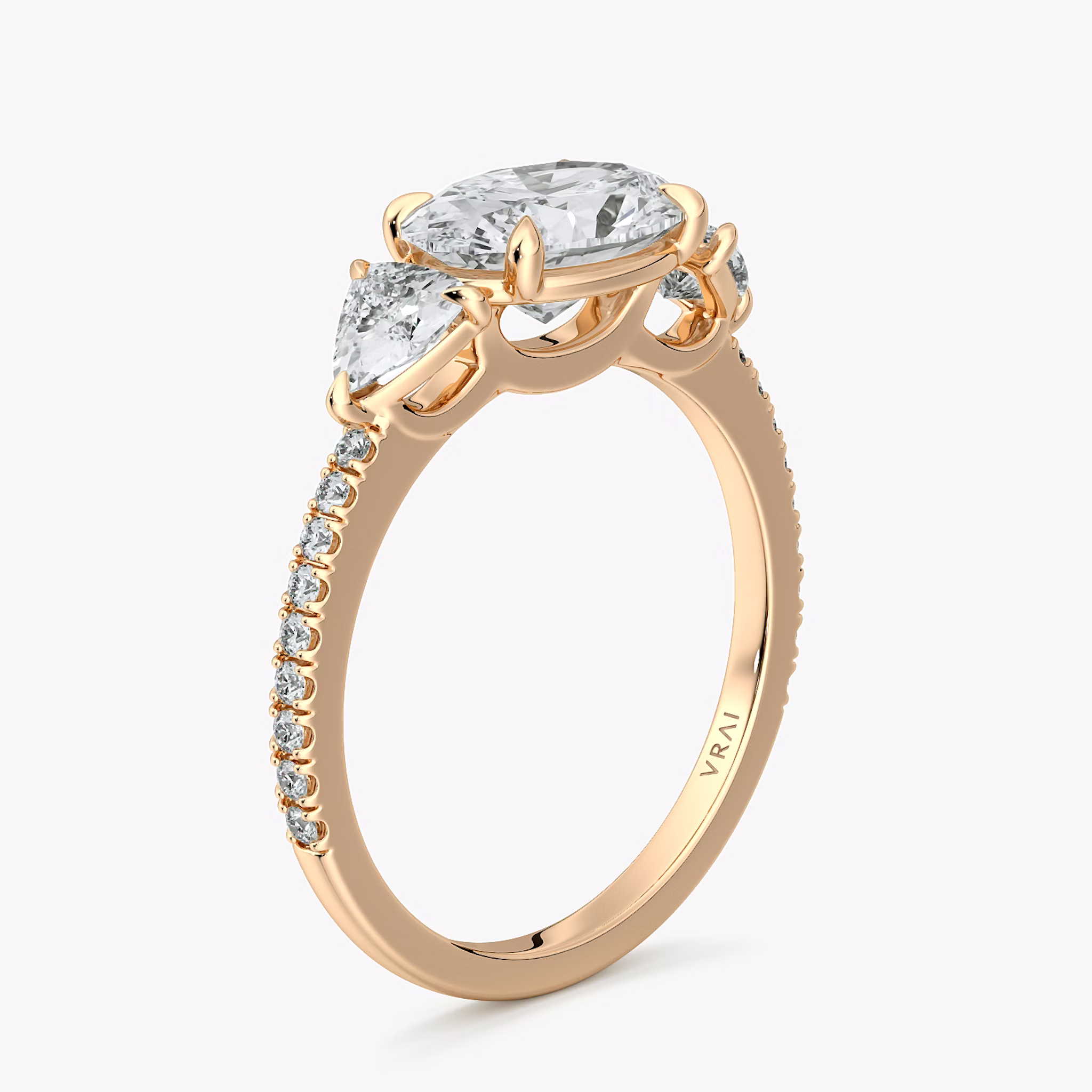 The Three Stone | Oval | 14k | Rose Gold | bandAccent: Pavé | diamondOrientation: horizontal | sideStoneCarat: 0.25ct | sideStoneShape: Trillion | caratWeight: other