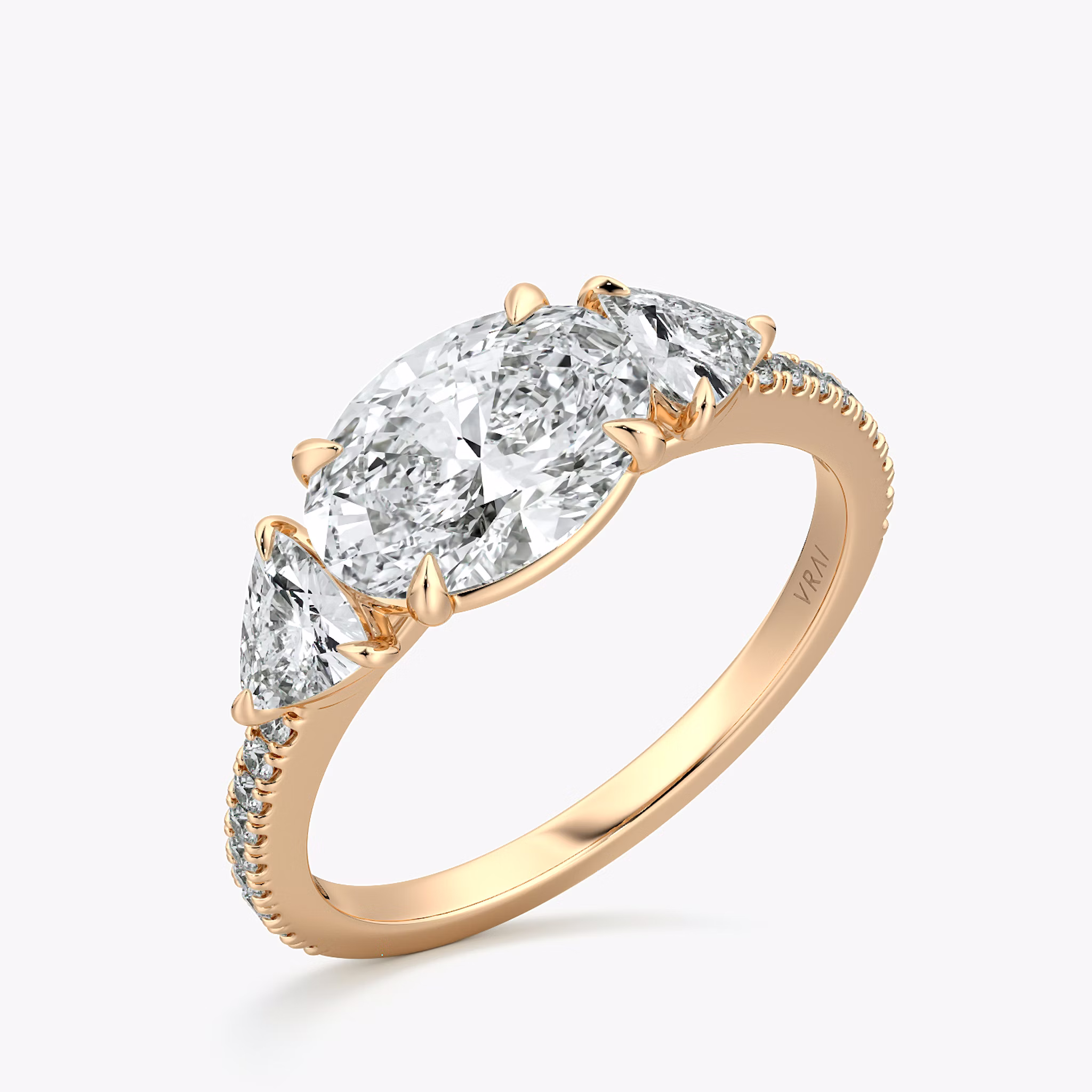The Three Stone | Oval | 14k | Rose Gold | bandAccent: Pavé | diamondOrientation: horizontal | sideStoneCarat: 0.25ct | sideStoneShape: Trillion | caratWeight: other