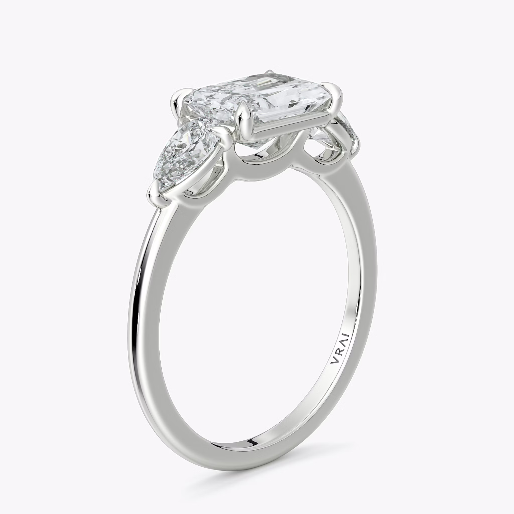 The Three Stone | Radiant | 18k | White Gold | bandAccent: Plain | diamondOrientation: horizontal | sideStoneCarat: 0.25ct | sideStoneShape: Pear | caratWeight: other