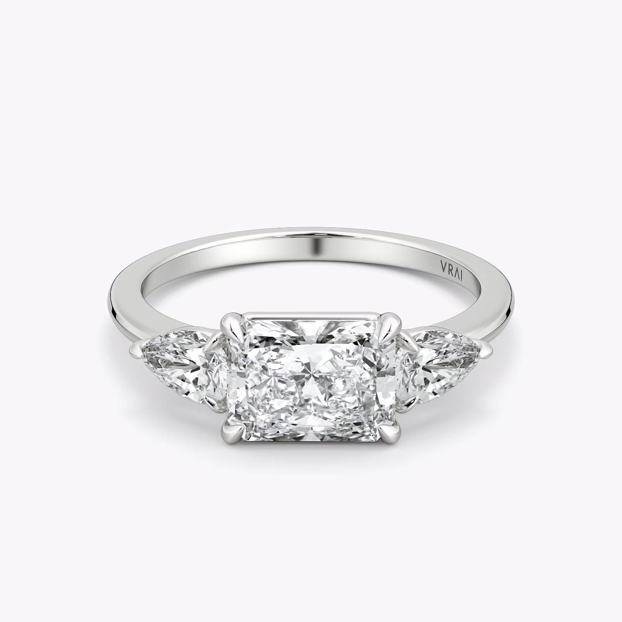 The Three Stone | Radiant | 18k | White Gold | bandAccent: Plain | diamondOrientation: horizontal | sideStoneCarat: 0.25ct | sideStoneShape: Pear | caratWeight: other