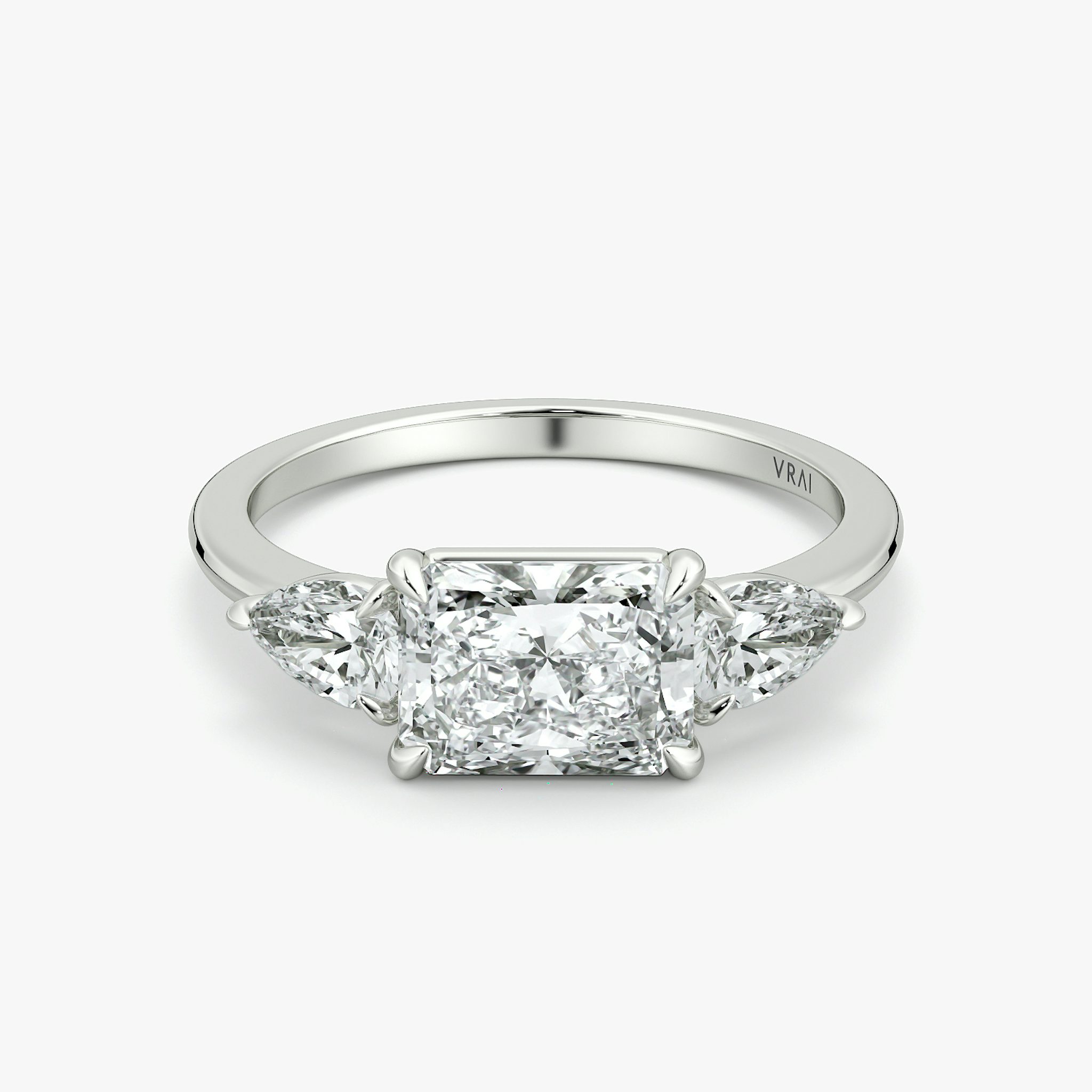 The Three Stone | Radiant | 18k | White Gold | bandAccent: Plain | diamondOrientation: horizontal | sideStoneCarat: 0.25ct | sideStoneShape: Pear | caratWeight: other