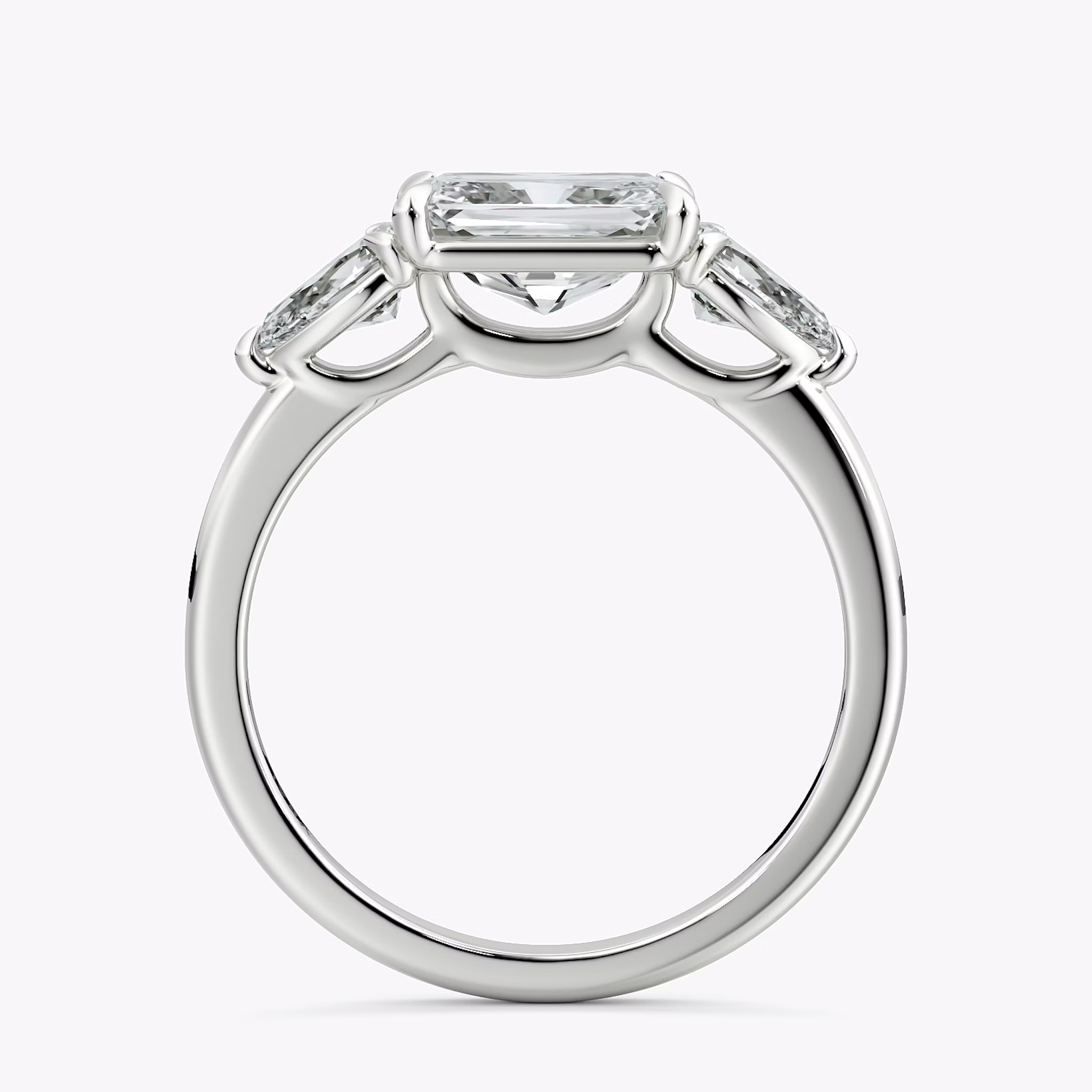 The Three Stone | Radiant | 18k | White Gold | bandAccent: Plain | diamondOrientation: horizontal | sideStoneCarat: 0.25ct | sideStoneShape: Pear | caratWeight: other