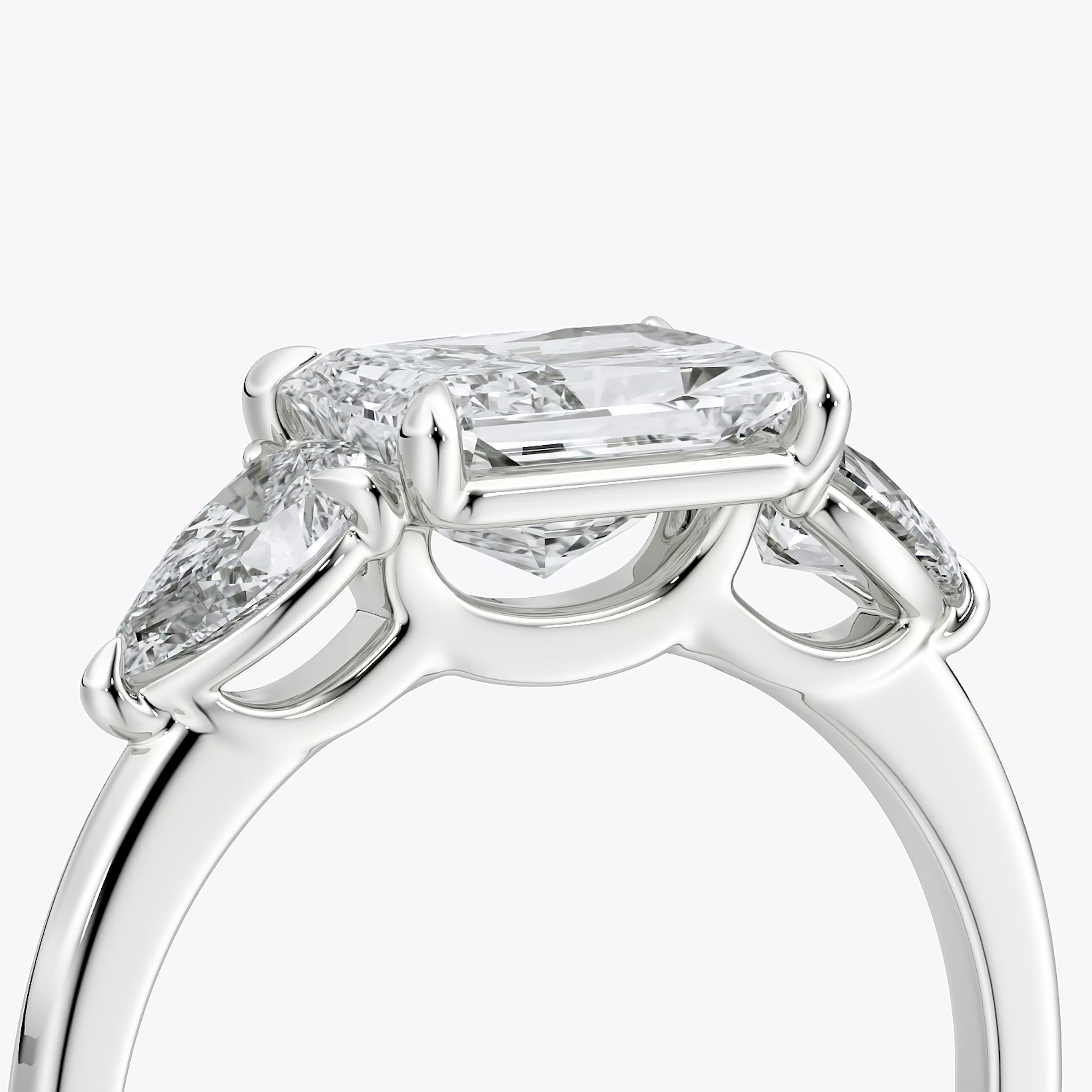 The Three Stone | Radiant | 18k | White Gold | bandAccent: Plain | diamondOrientation: horizontal | sideStoneCarat: 0.25ct | sideStoneShape: Pear | caratWeight: other