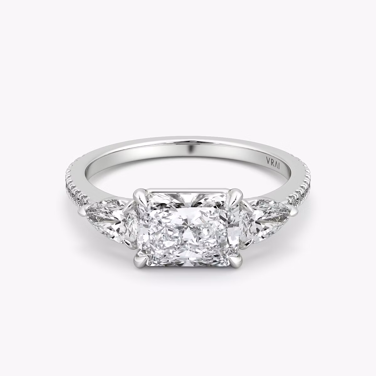 The Three Stone | Radiant | Platinum | bandAccent: Pavé | diamondOrientation: horizontal | sideStoneCarat: 0.25ct | sideStoneShape: Pear | caratWeight: other