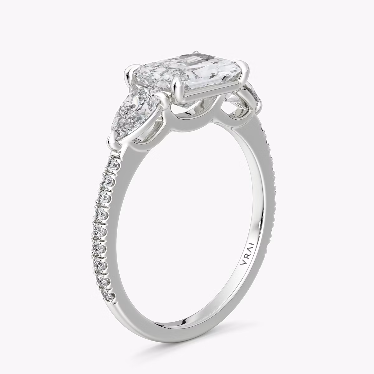 The Three Stone | Radiant | Platinum | bandAccent: Pavé | diamondOrientation: horizontal | sideStoneCarat: 0.25ct | sideStoneShape: Pear | caratWeight: other